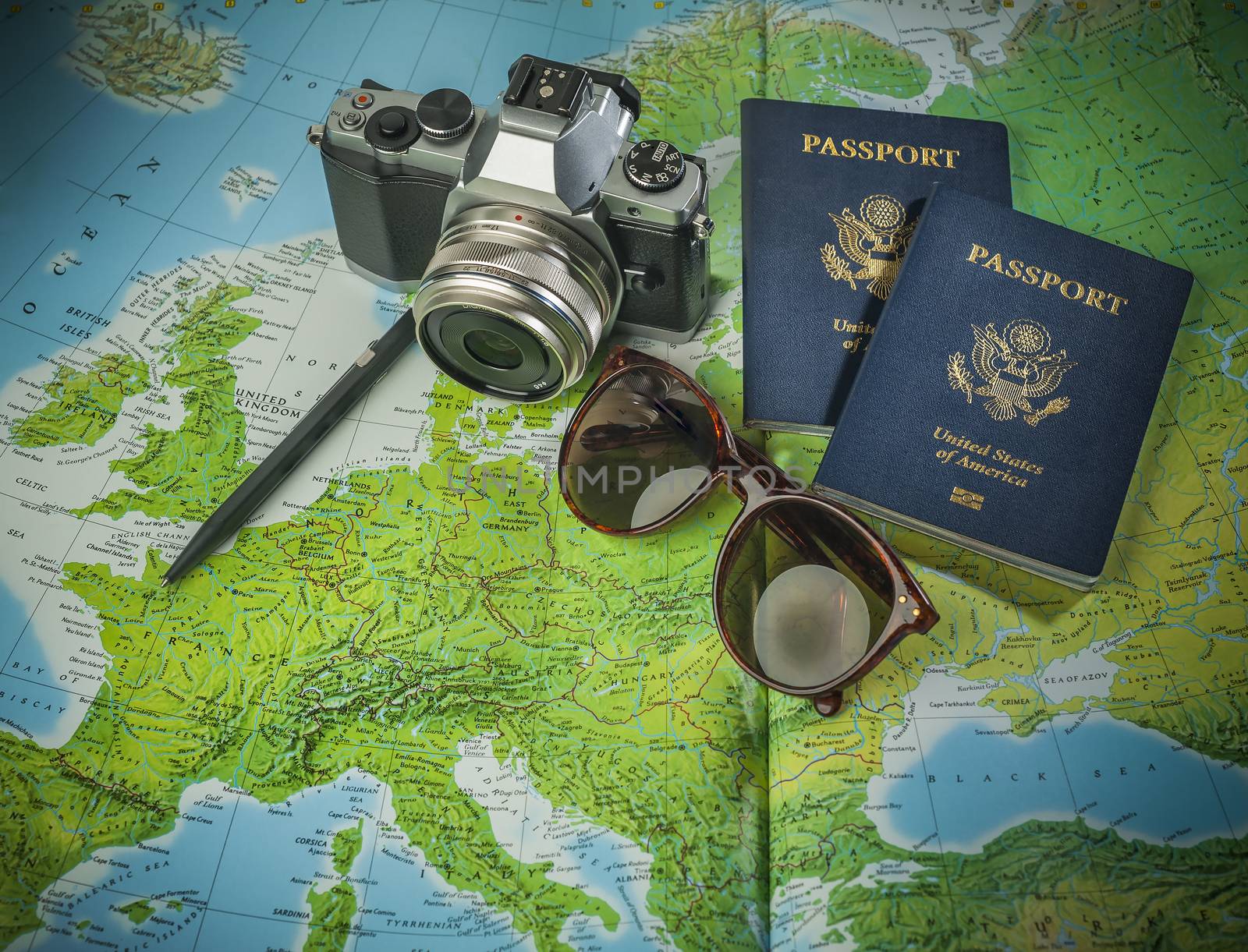 Passports for travel in Europe,camera and glasses on a map