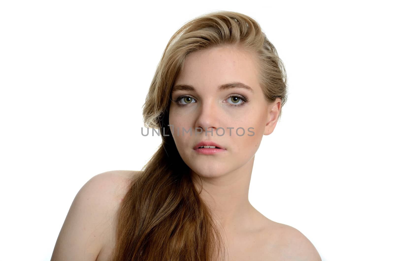 Young girl with kind and soft face expression. Portrait of female model with blond hairs.