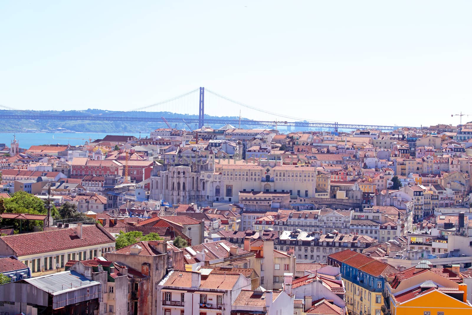 Aerial view with colored houses and the 25 abril bridge in Lisbon Portugal