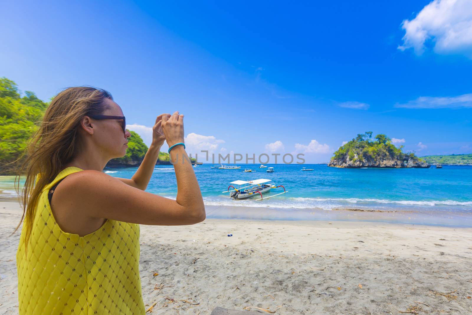 Cheerful Girl Talking Pictures with Digital Camera, Nusa Penida, Indonesia.
released