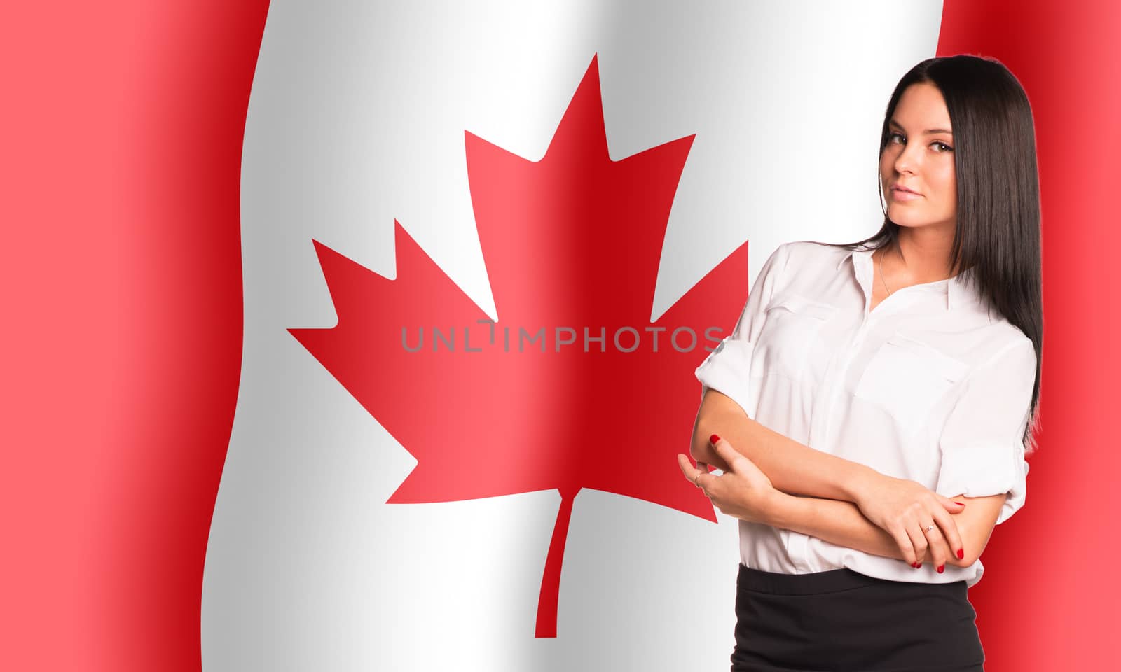 Smiling woman with crossed arms on Canada flag background