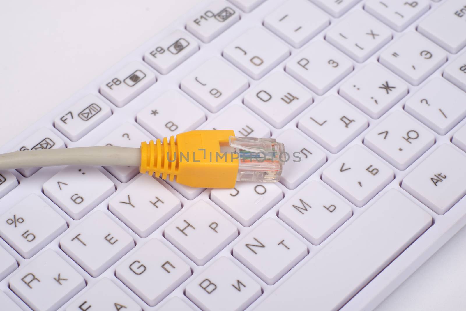 Computer keyboard with yellow cable, top view