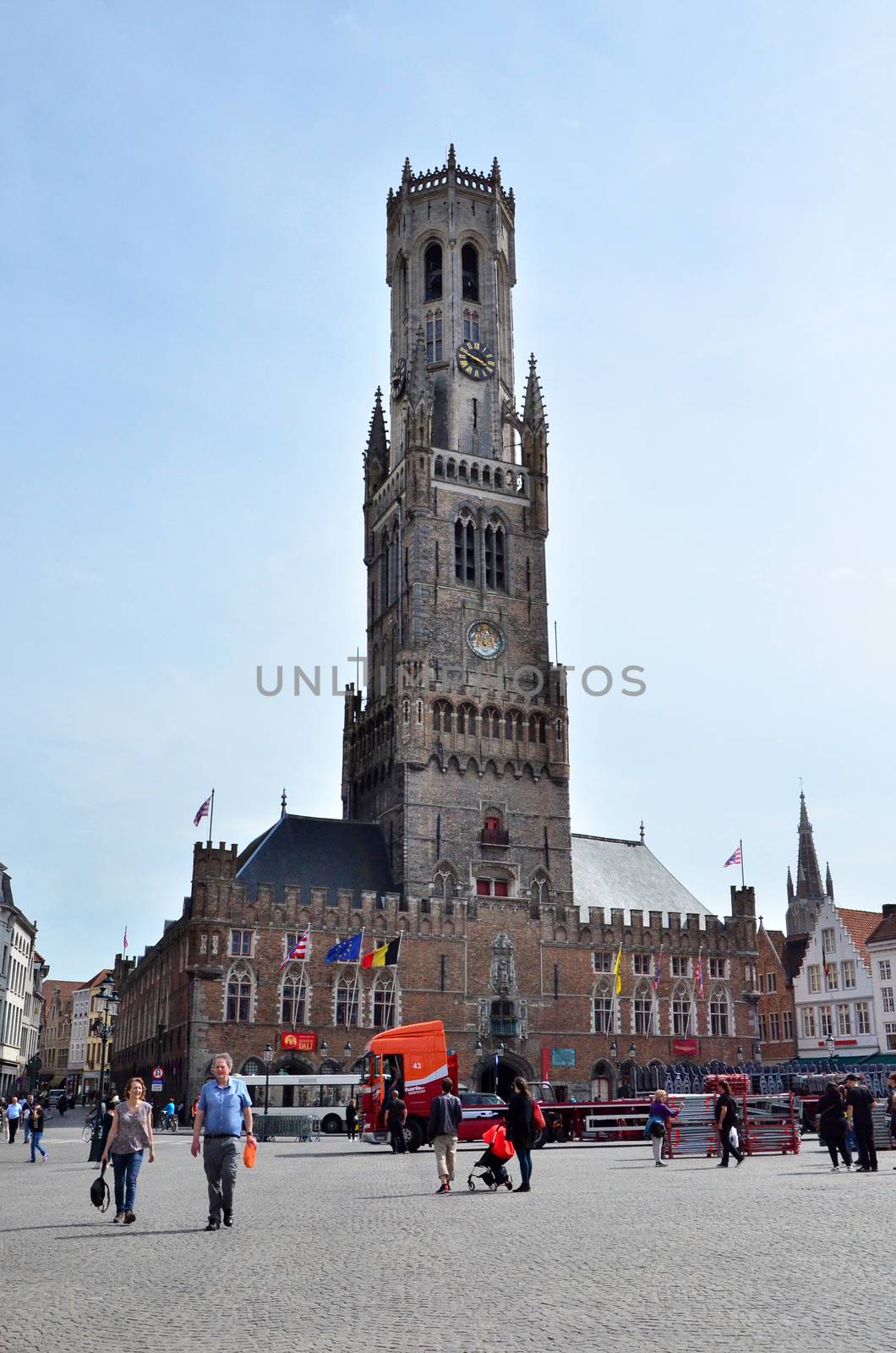 Bruges, Belgium - May 11, 2015: Tourist visit Belfry of Bruges on Grote Markt square on May 11, 2015. The historic city centre is a prominent World Heritage Site of UNESCO.