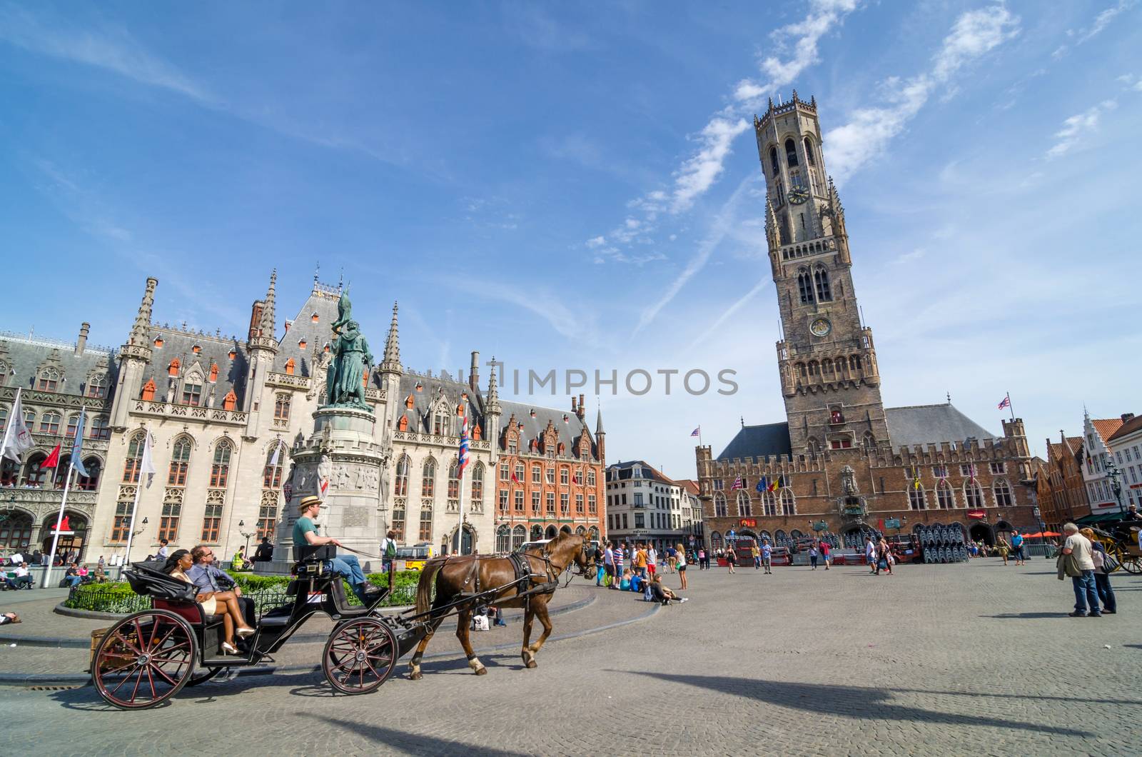 Bruges, Belgium - May 11, 2015: Tourist on Grote Markt square in Bruges, Belgium by siraanamwong