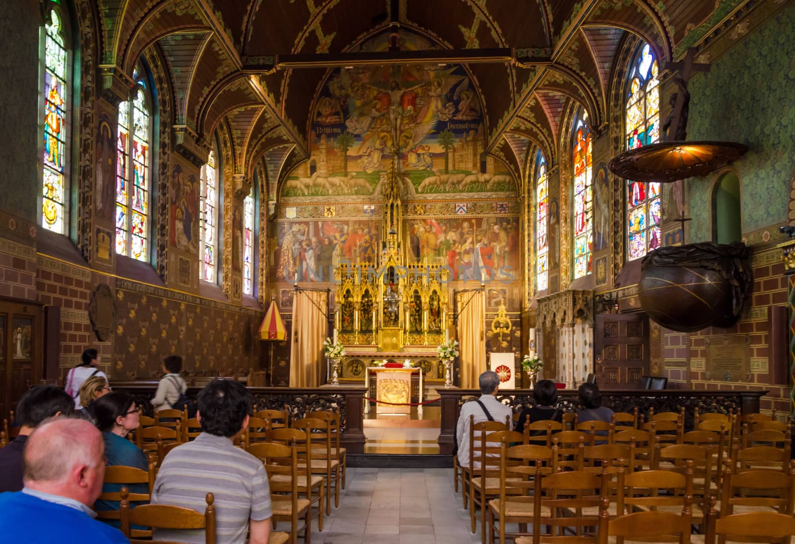 Bruges, Belgium - May 11, 2015: Tourist visit Interior of Basilica of the Holy Blood in Bruges, Belgium on May 11, 2015. Basilica is located in the Burg square and consists of a lower and upper chapel. 