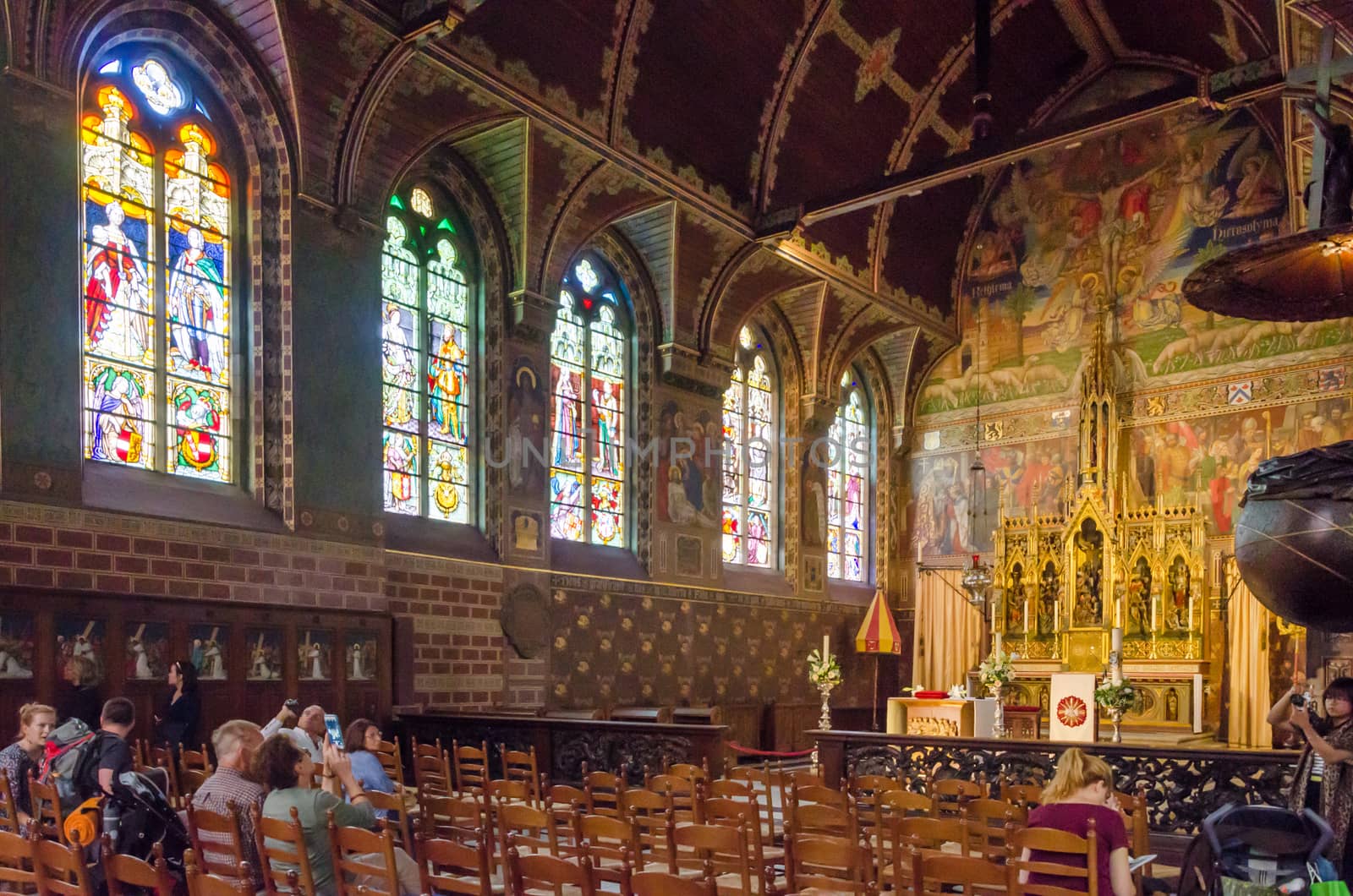 Bruges, Belgium - May 11, 2015: Tourist visit Interior of Basilica of the Holy Blood in Bruges, Belgium on May 11, 2015. Basilica is located in the Burg square and consists of a lower and upper chapel. 