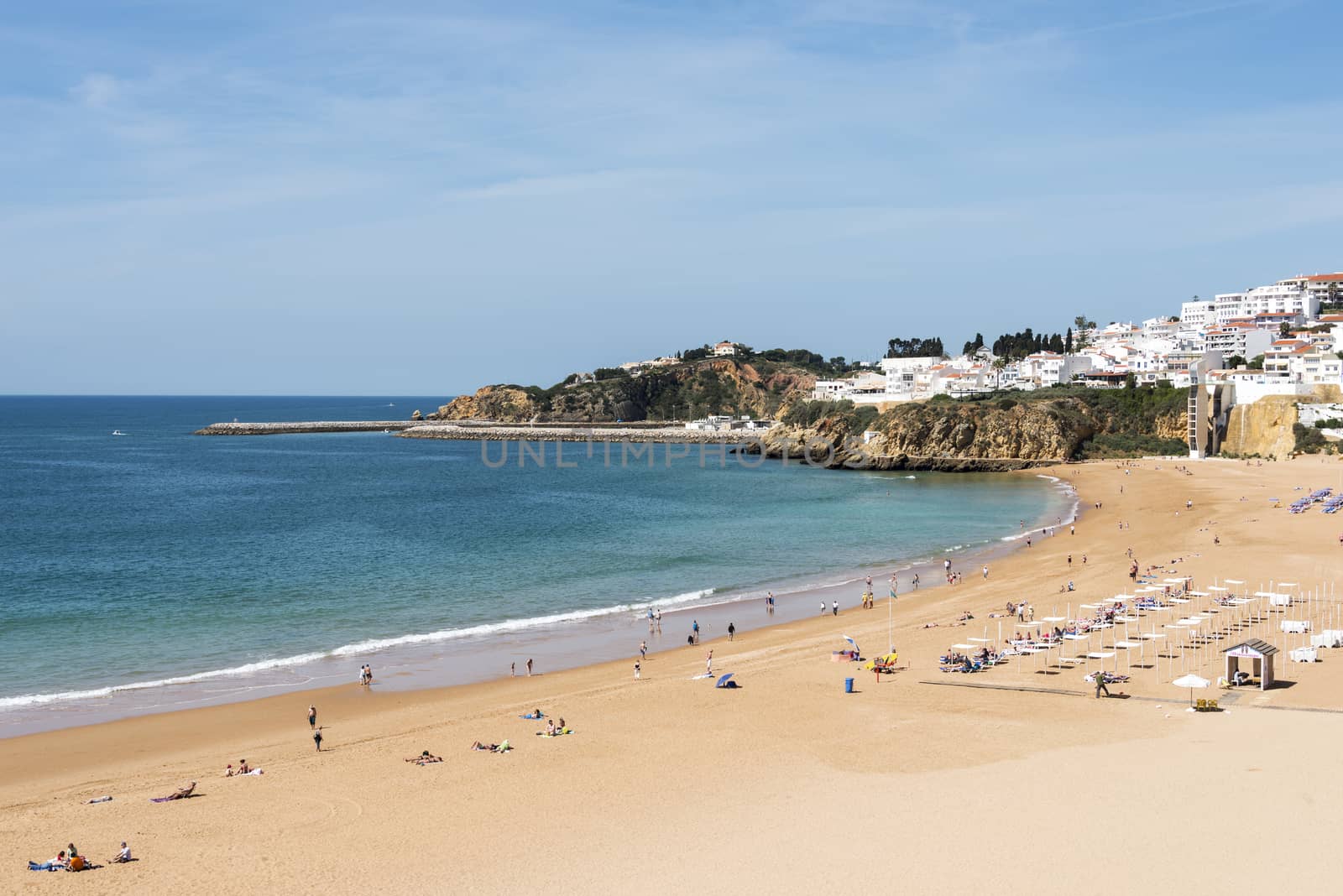 people relax and walk on the beach in albufeira algarve area of portugal