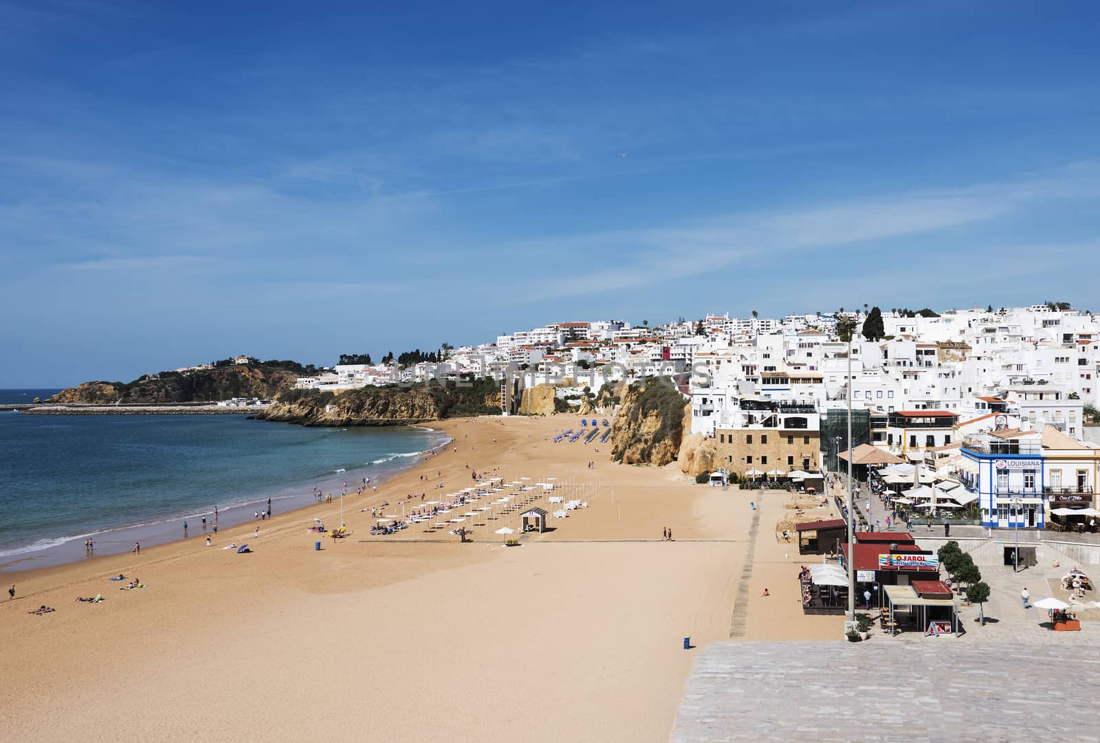 people relax and walk on the beach in albufeira algarve area of portugal