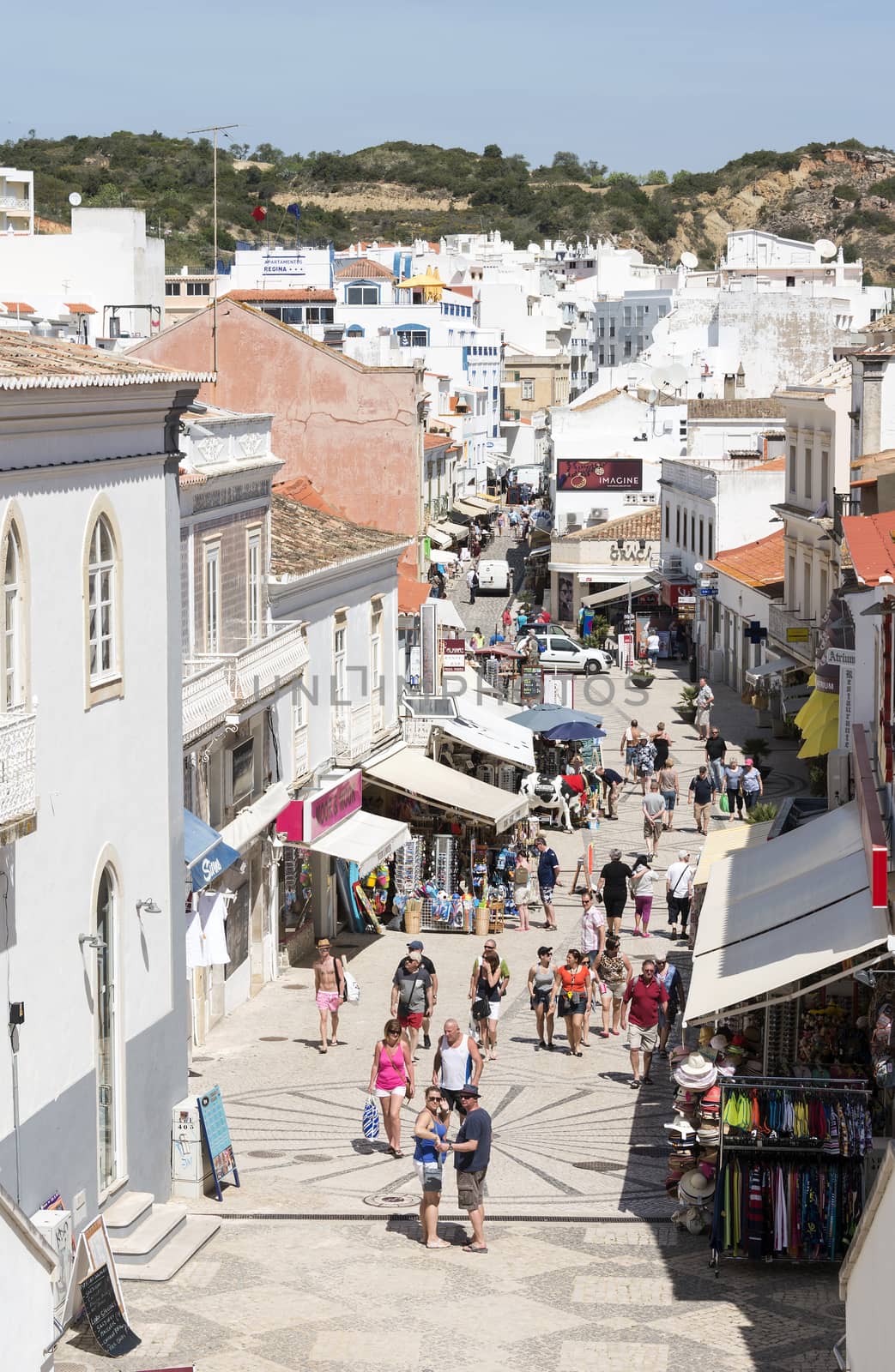 people shopping in the main street albufeira in portugal during vacation