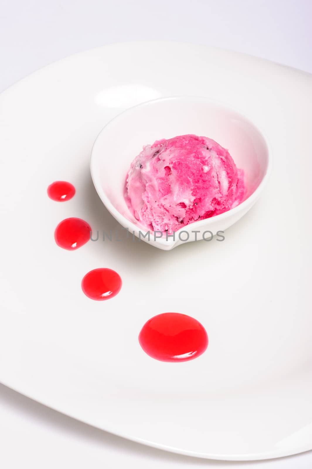 Raspberry layered cheese cake and pink ice cream ball, isolated on white