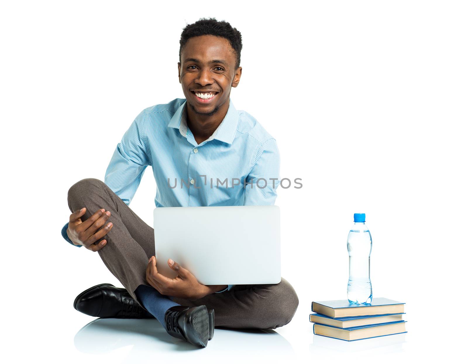 Happy african american college student with laptop, books sittin by vlad_star