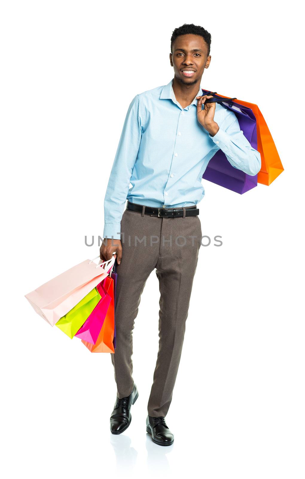 Happy african american man holding shopping bags on white background. Holidays concept