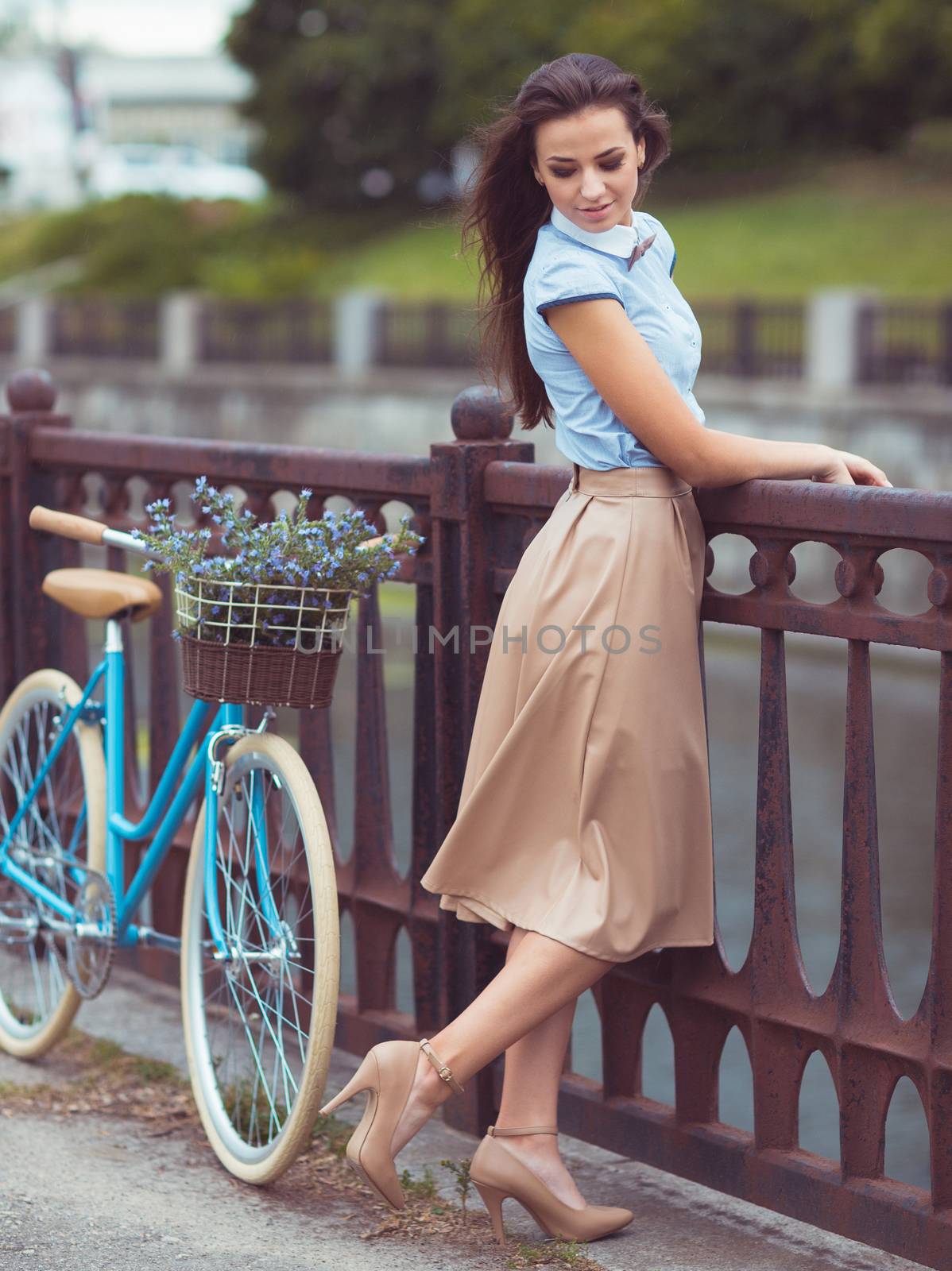 Young beautiful, elegantly dressed woman with bicycle. Beauty, fashion and lifestyle