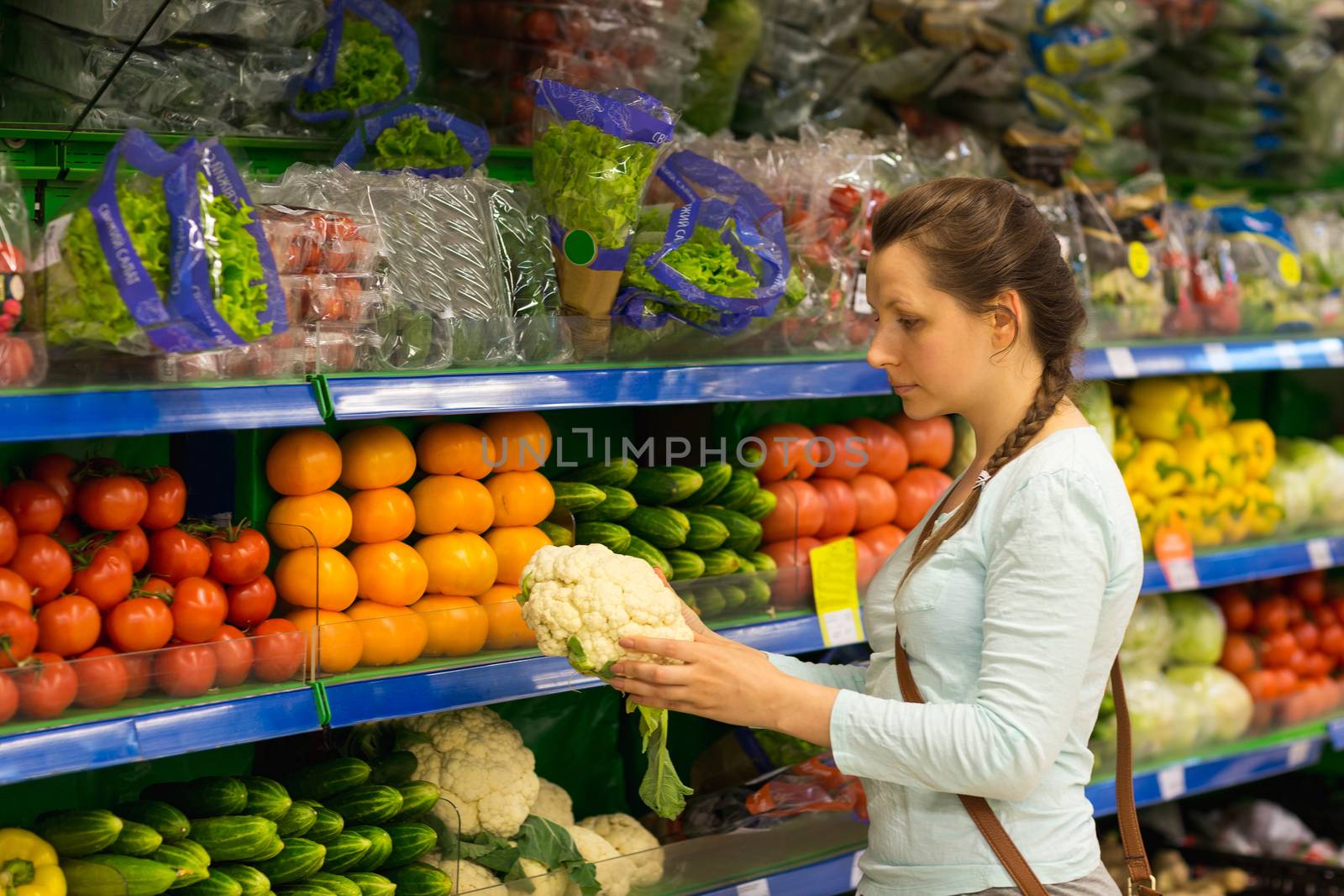 Beautiful young woman shopping for cereal, bulk in a grocery sto by vlad_star