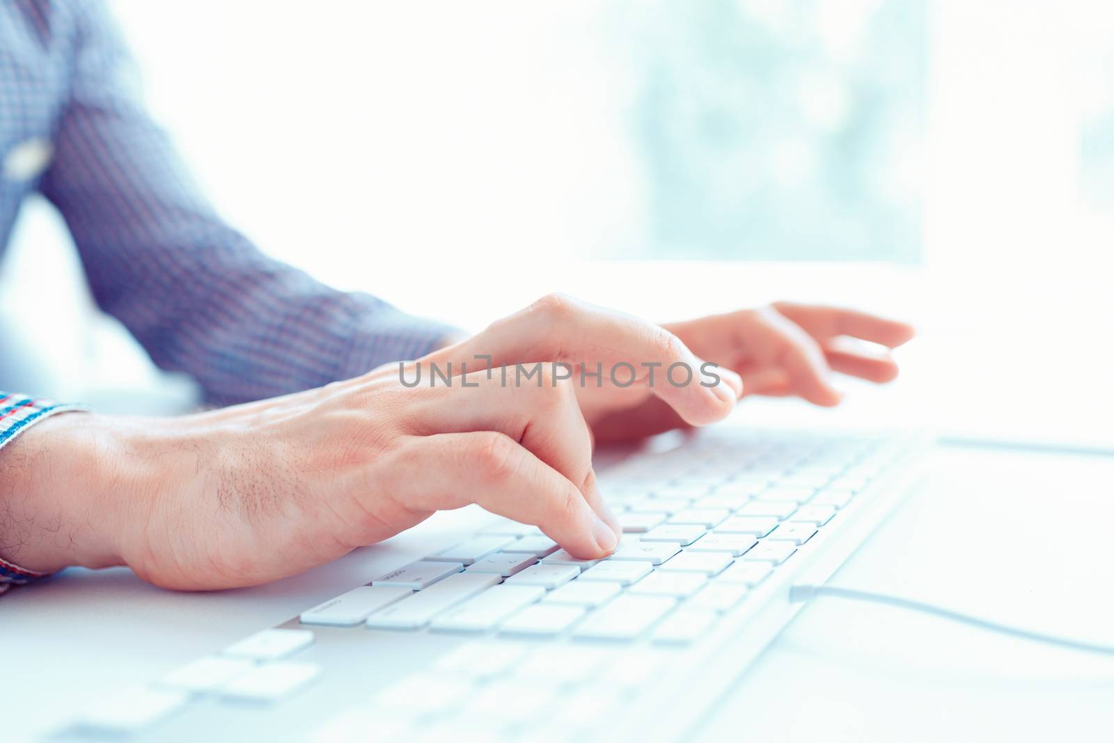 Male office worker typing on the keyboard by vlad_star