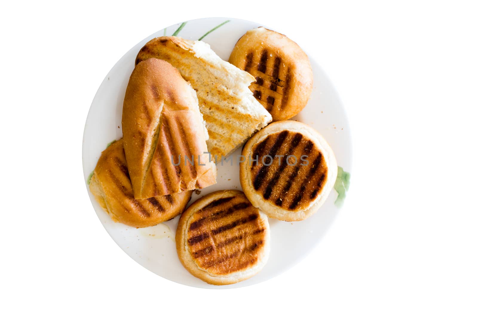 Plate of fresh crusty golden toasted buns and baguette to accompany a meal or serve as an appetizer viewed from above on a plate, isolated on white