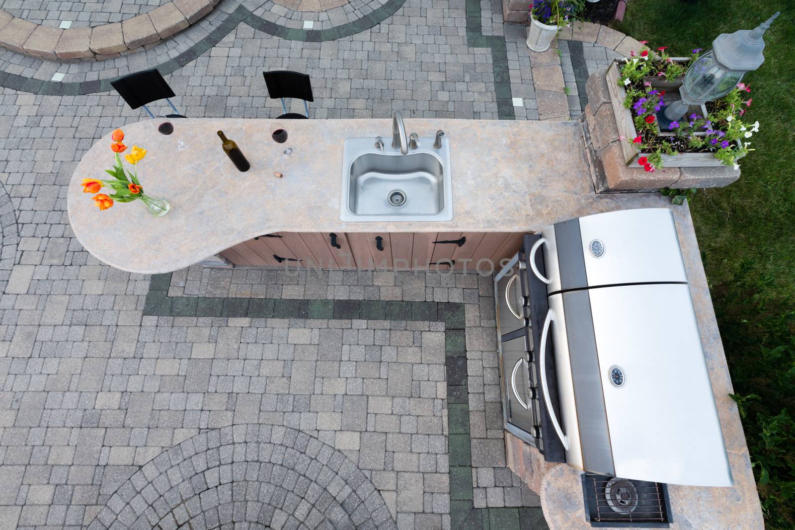 Outdoor summer kitchen with barbecue and sink by coskun