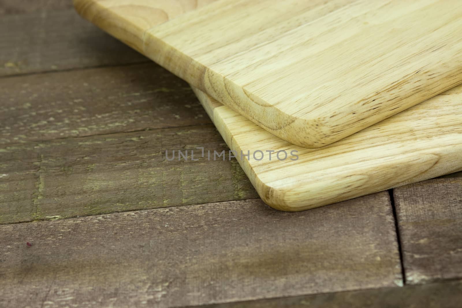 Wooden chopping board on an old table