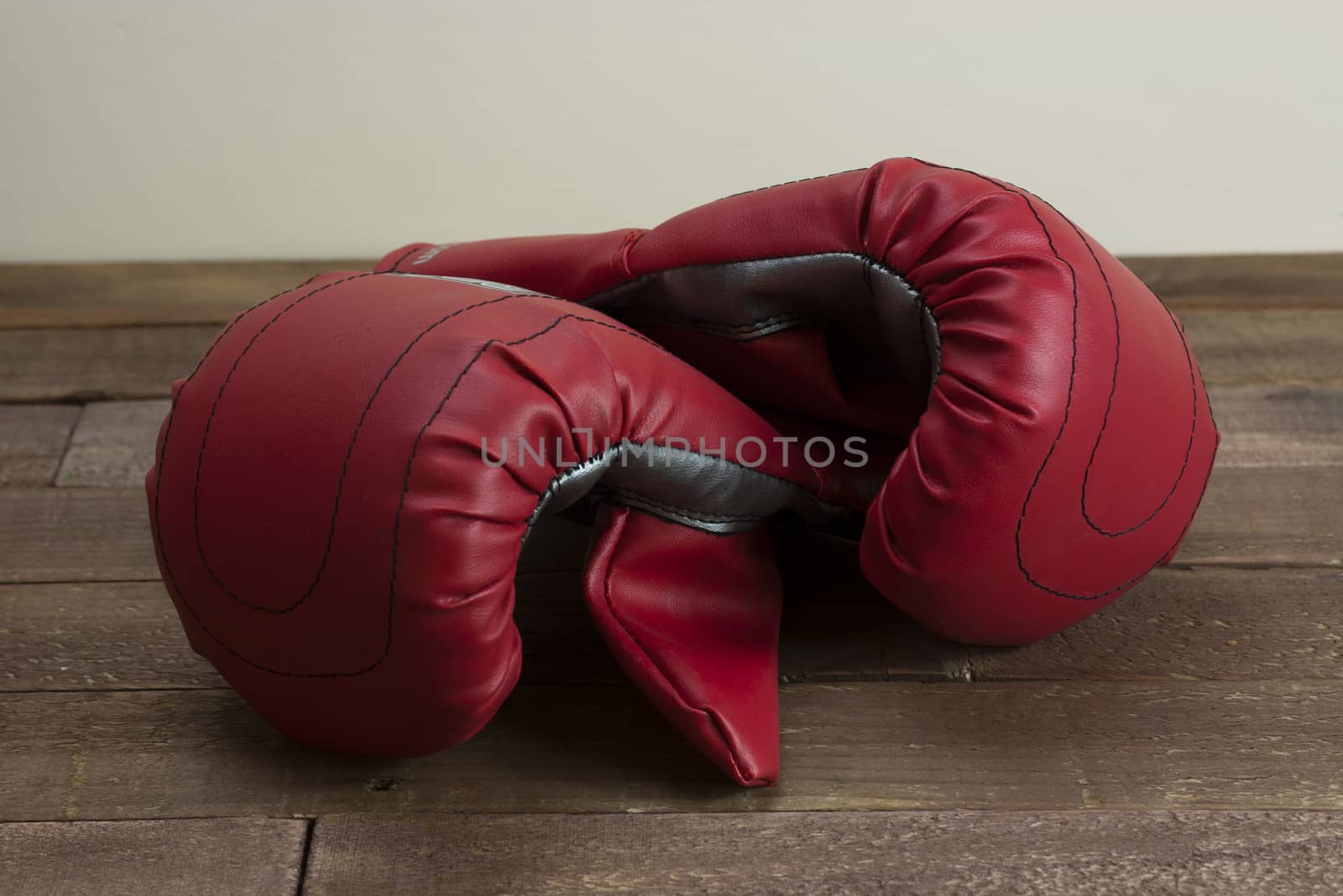 pair of boxing gloves on a wooden floor