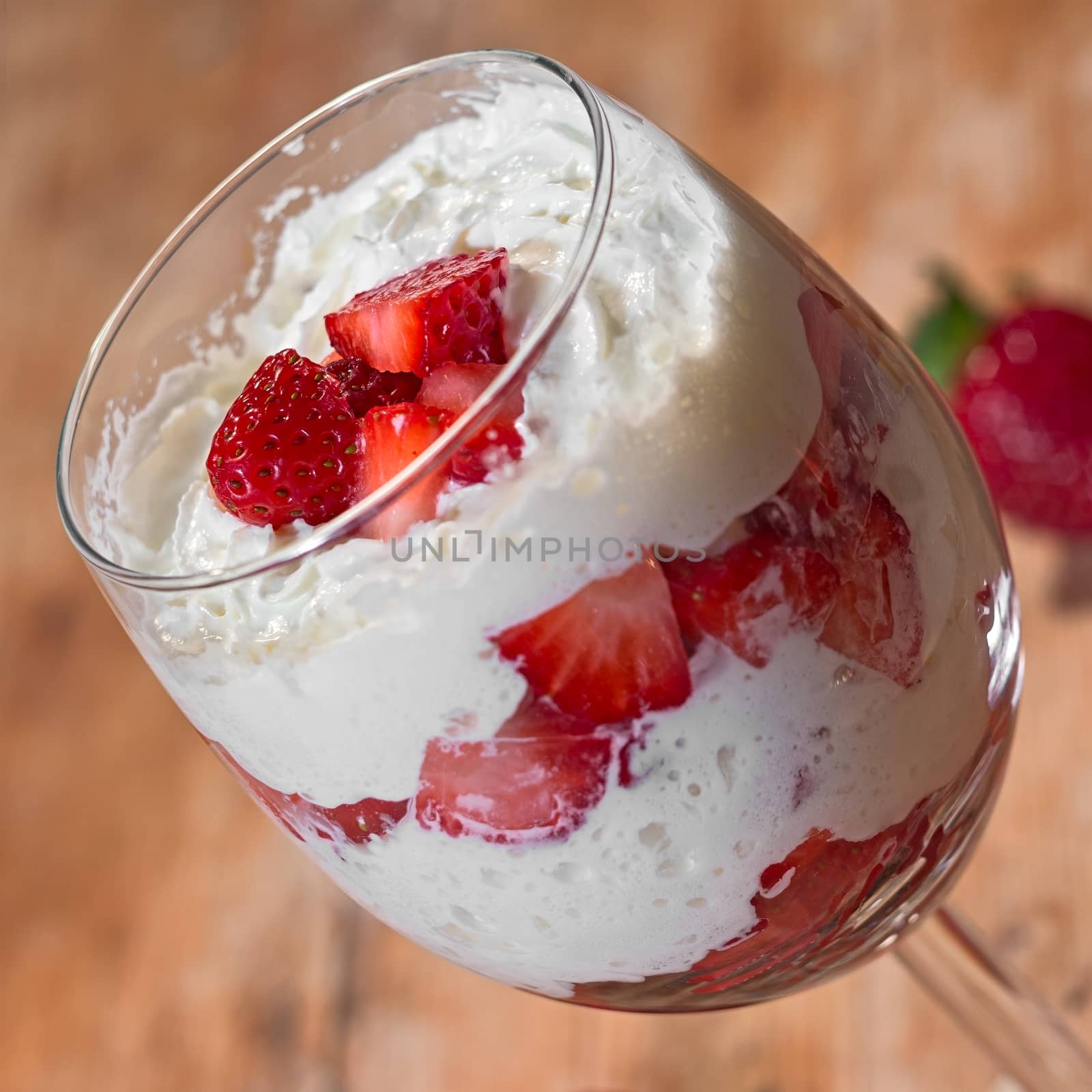 strawberry with whipped cream in glass