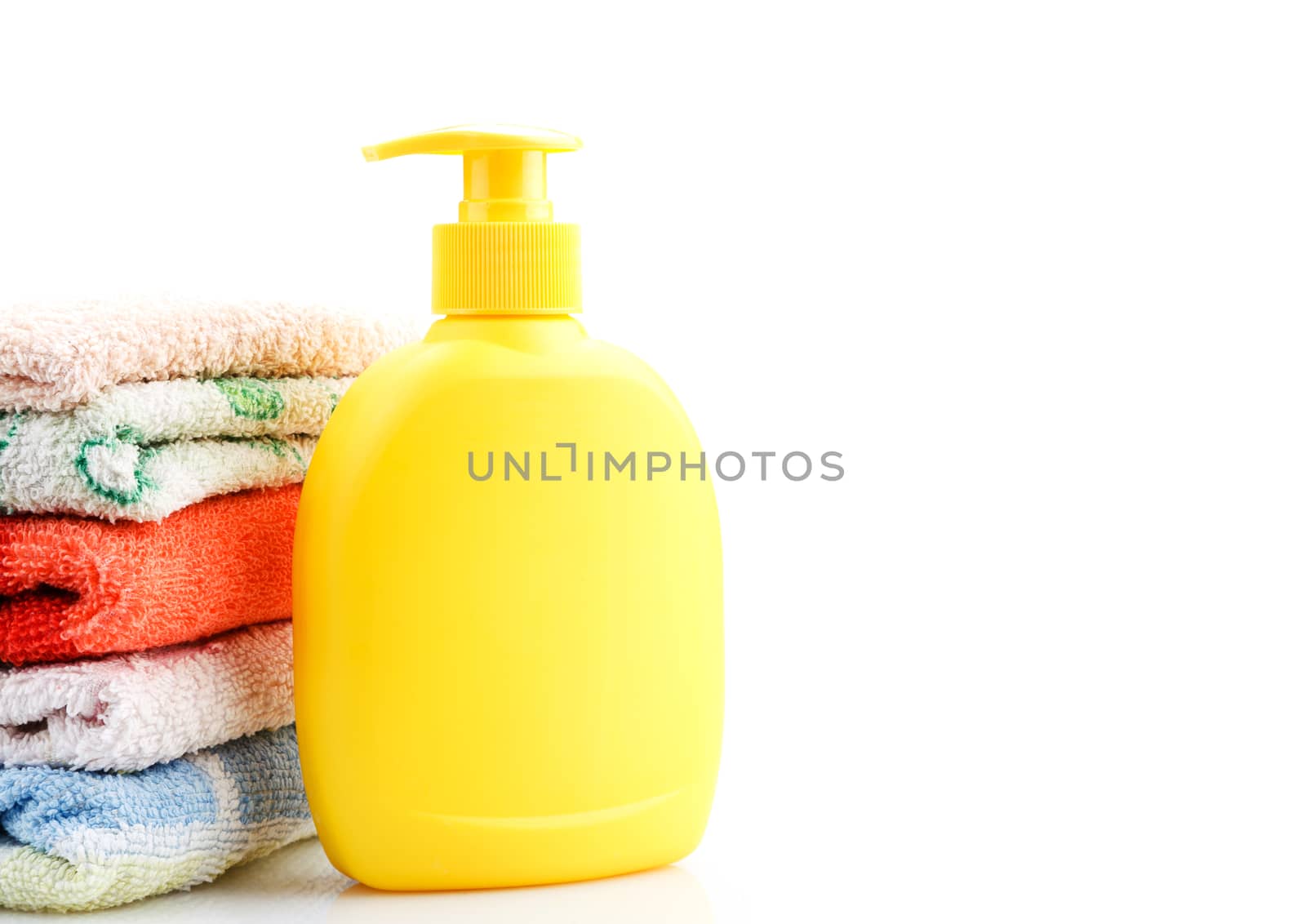 Towels and Soap Dispenser isolated on white