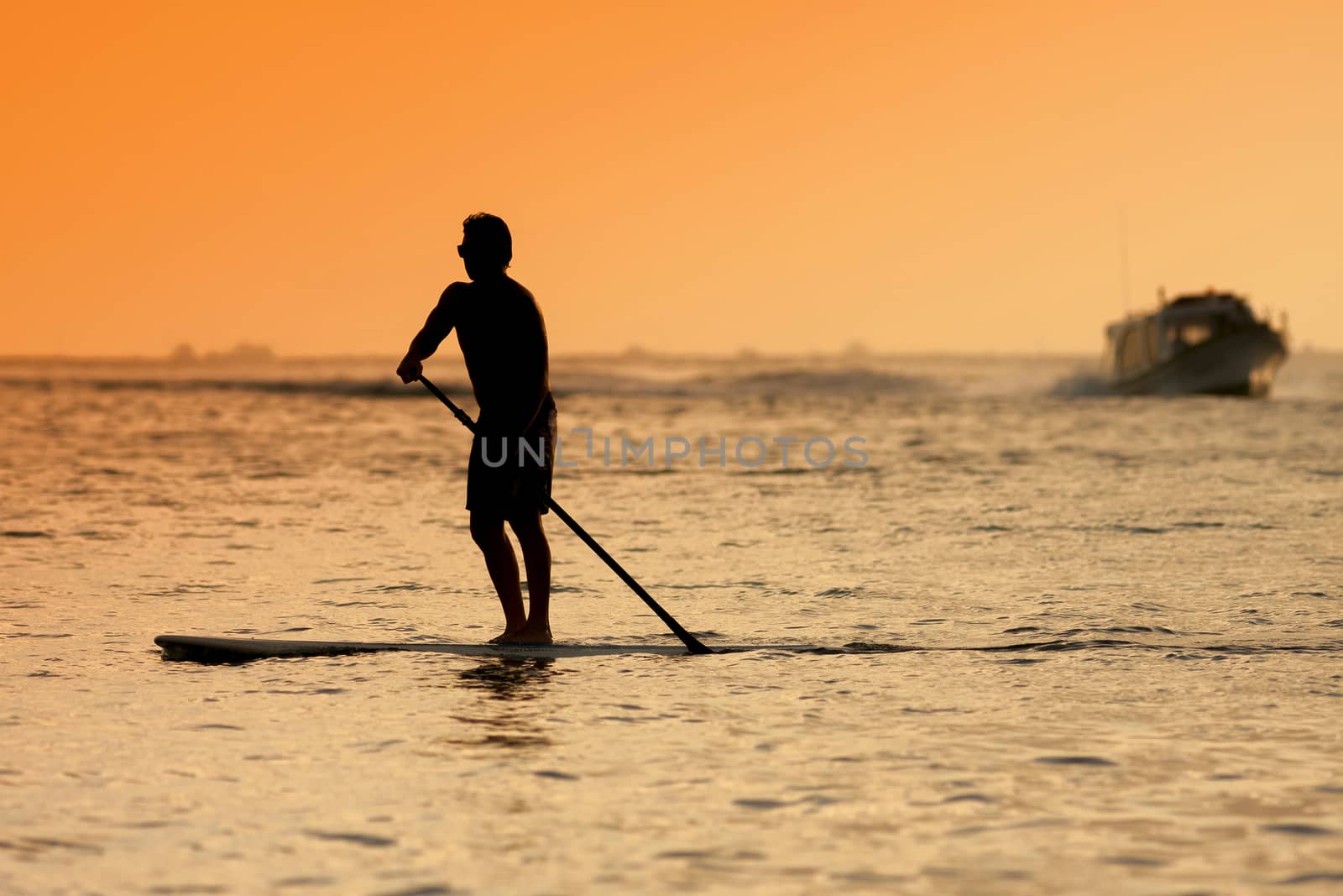 Surfer  with a surfboard at Sunset Tme, Bali, Indonesia
released