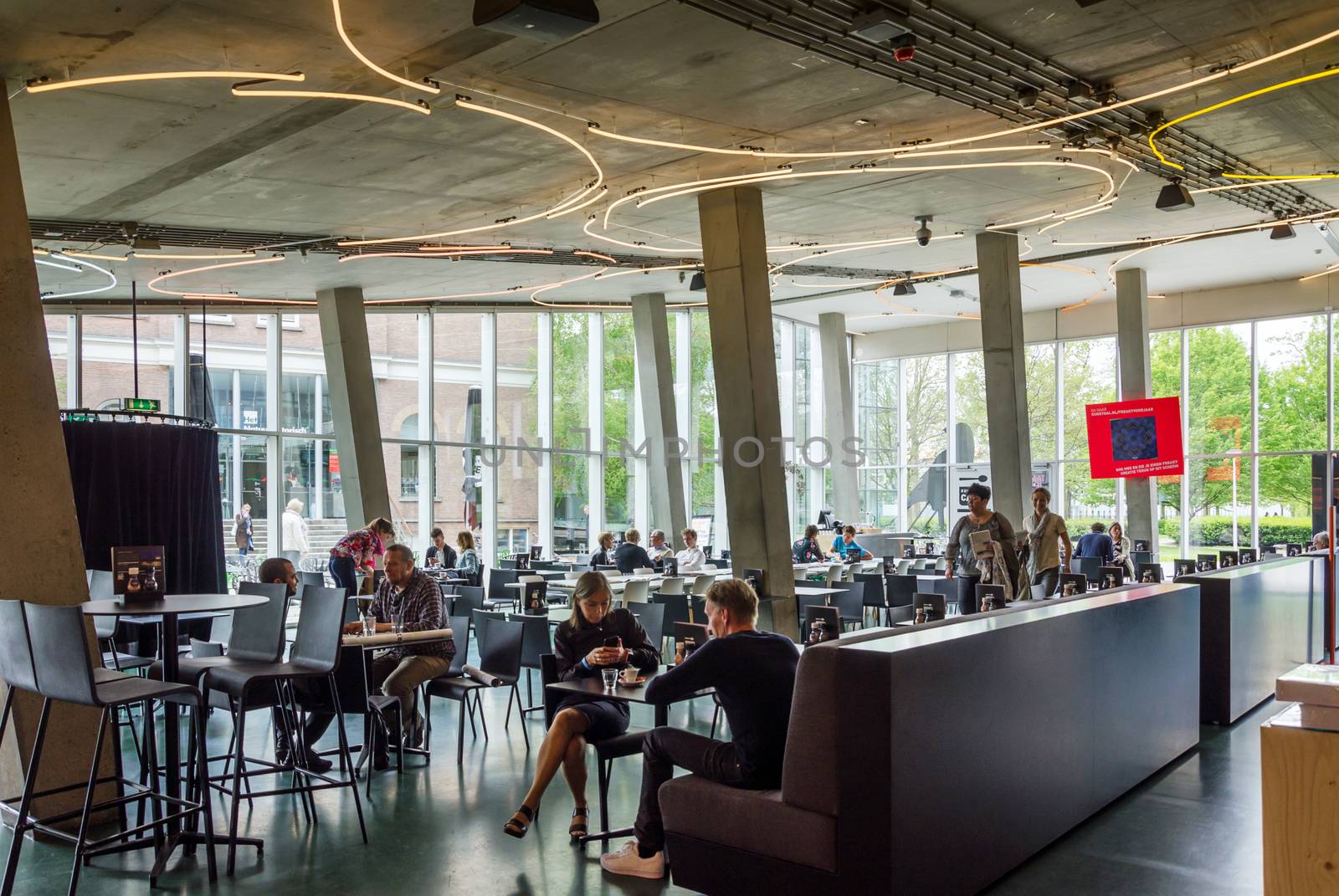 Rotterdam, Netherlands - May 9, 2015: People at Cafeteria of Kunsthal museum in Museumpark, Rotterdam on May 9, 2015. The building was designed by the Dutch architect Rem Koolhaas.