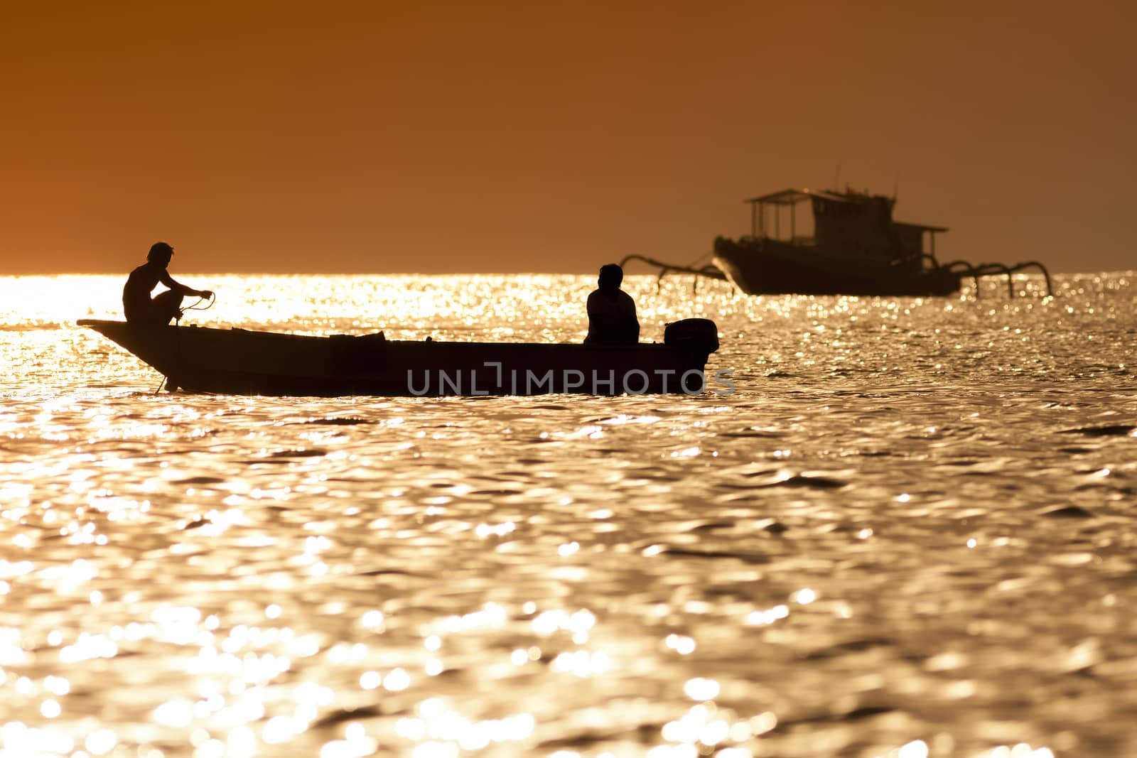 Sunset scene of  fisherman long tailed boat in Bali, Indonesia.
