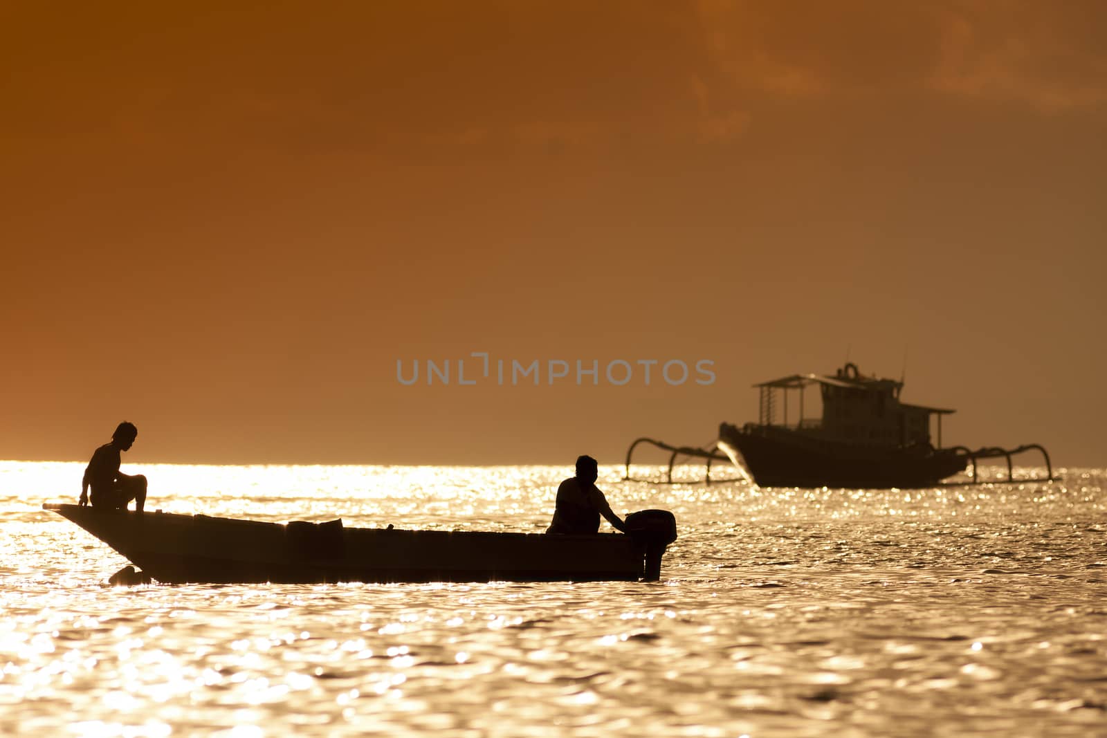 Sunset scene of  fisherman long tailed boat in Bali, Indonesia.