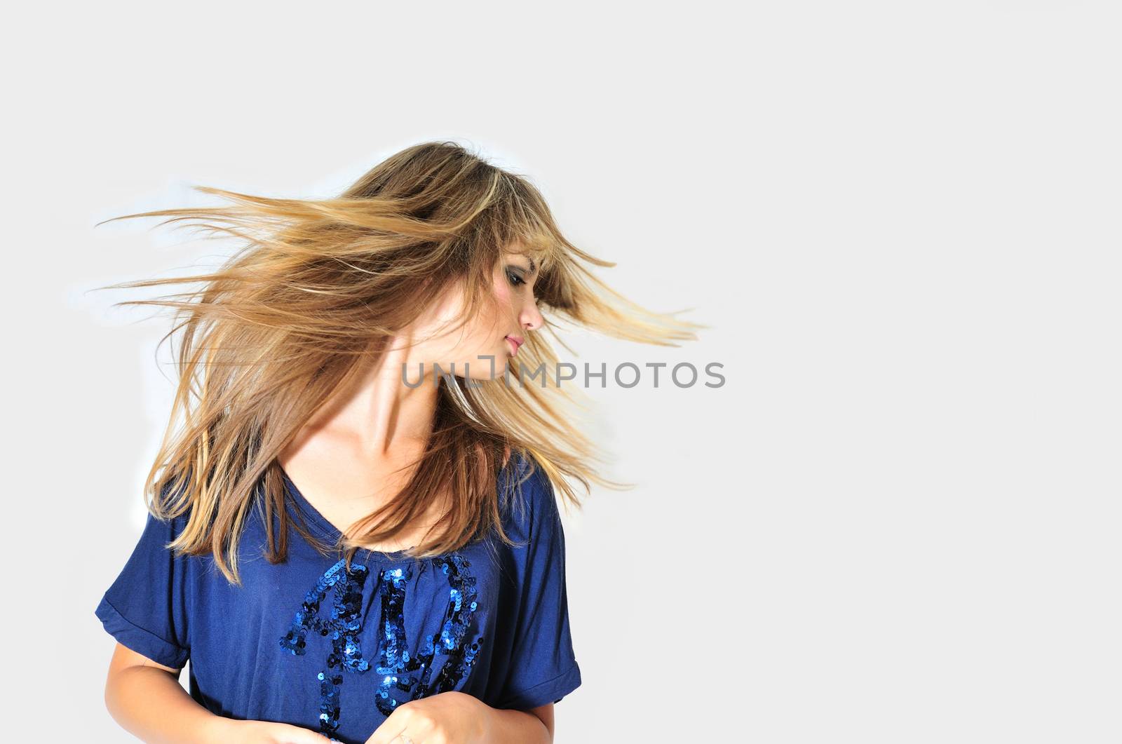 Young teen girl dancing with wind in hair