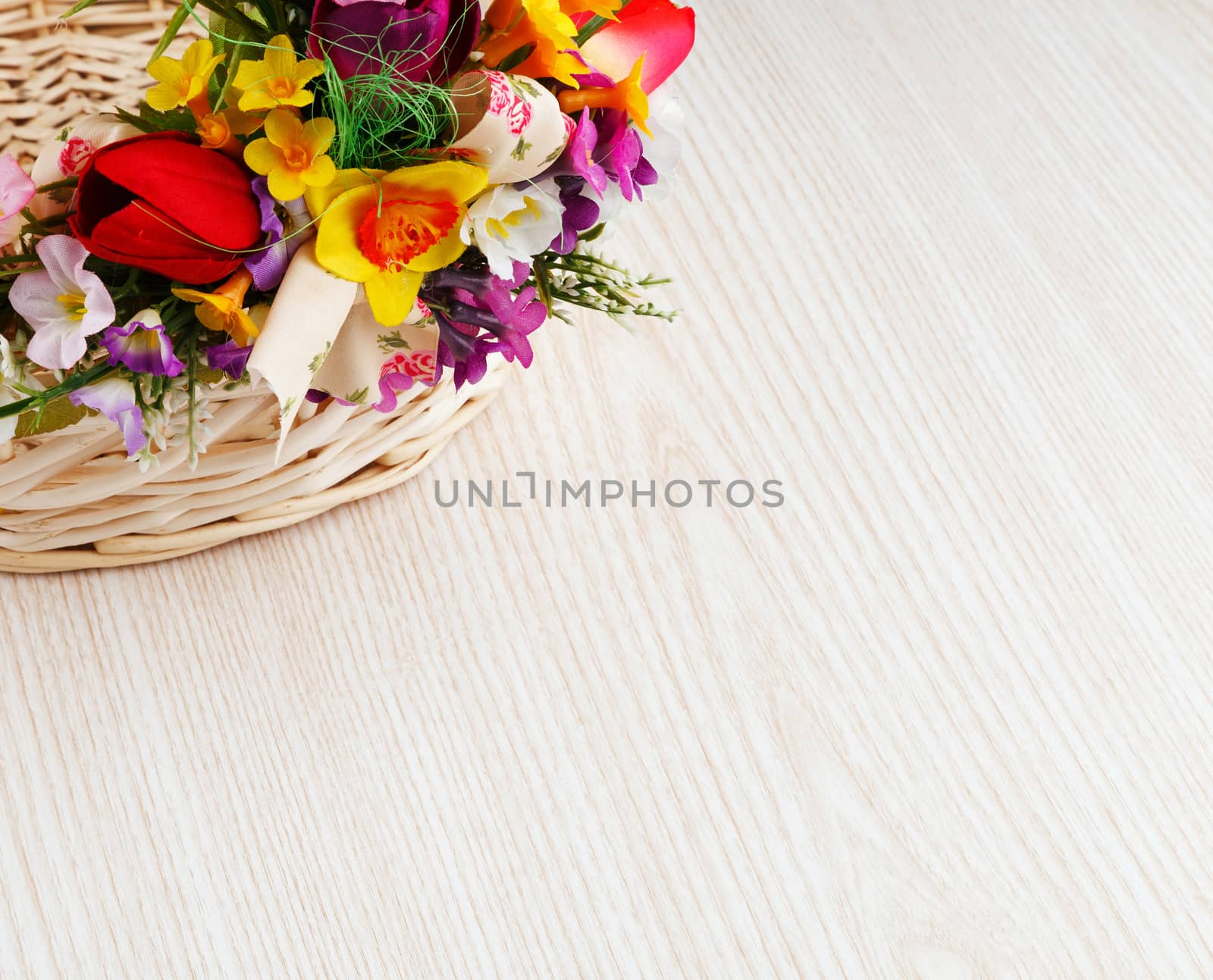 artifical flowers on a wooden background