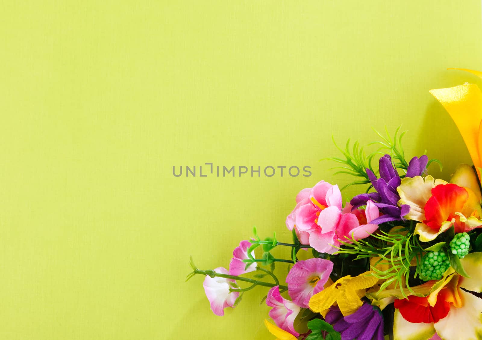 artificial flower arrangement on a yellow background with blank  for advertisement