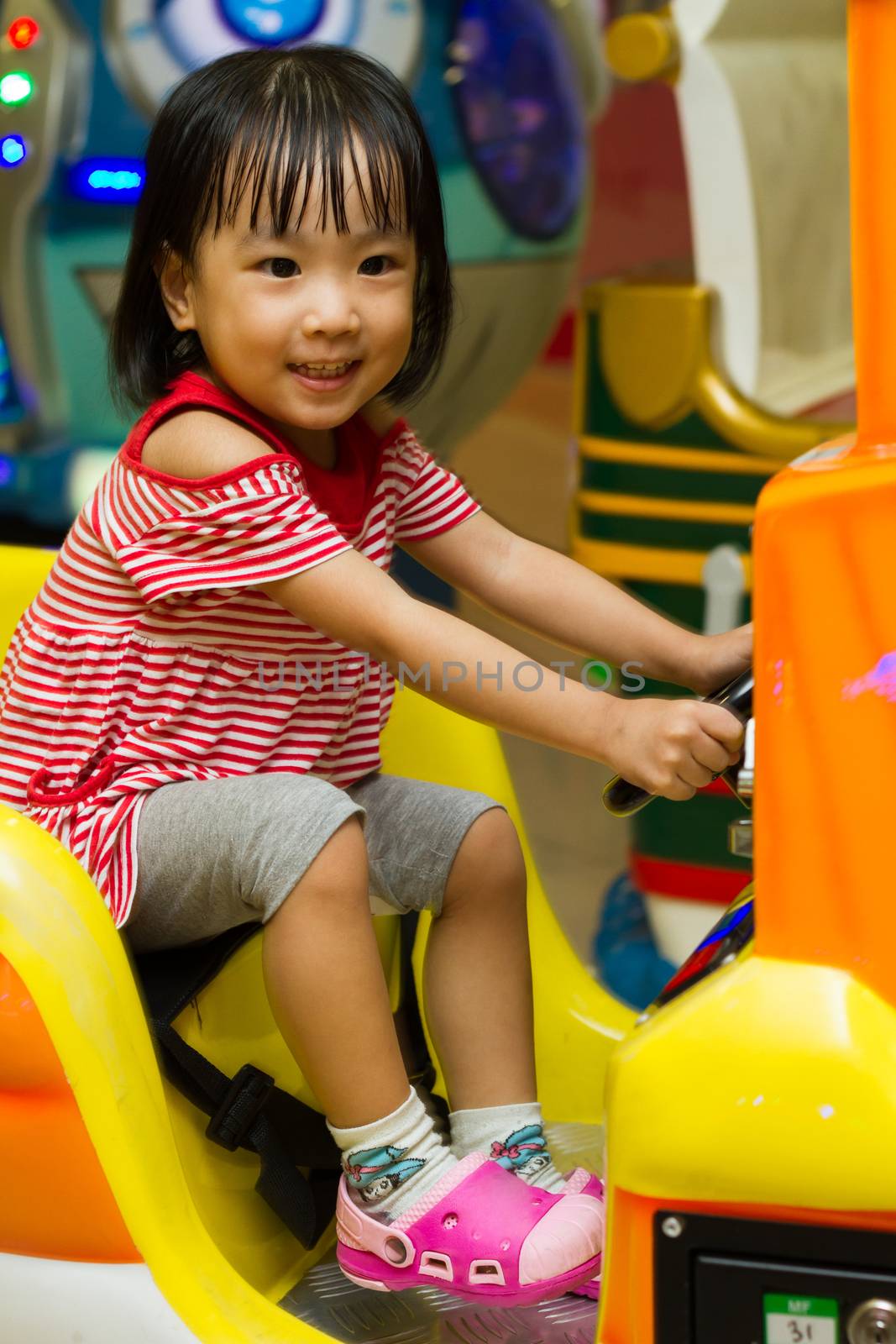 Happy Asian Chinese girl at indoor playground
