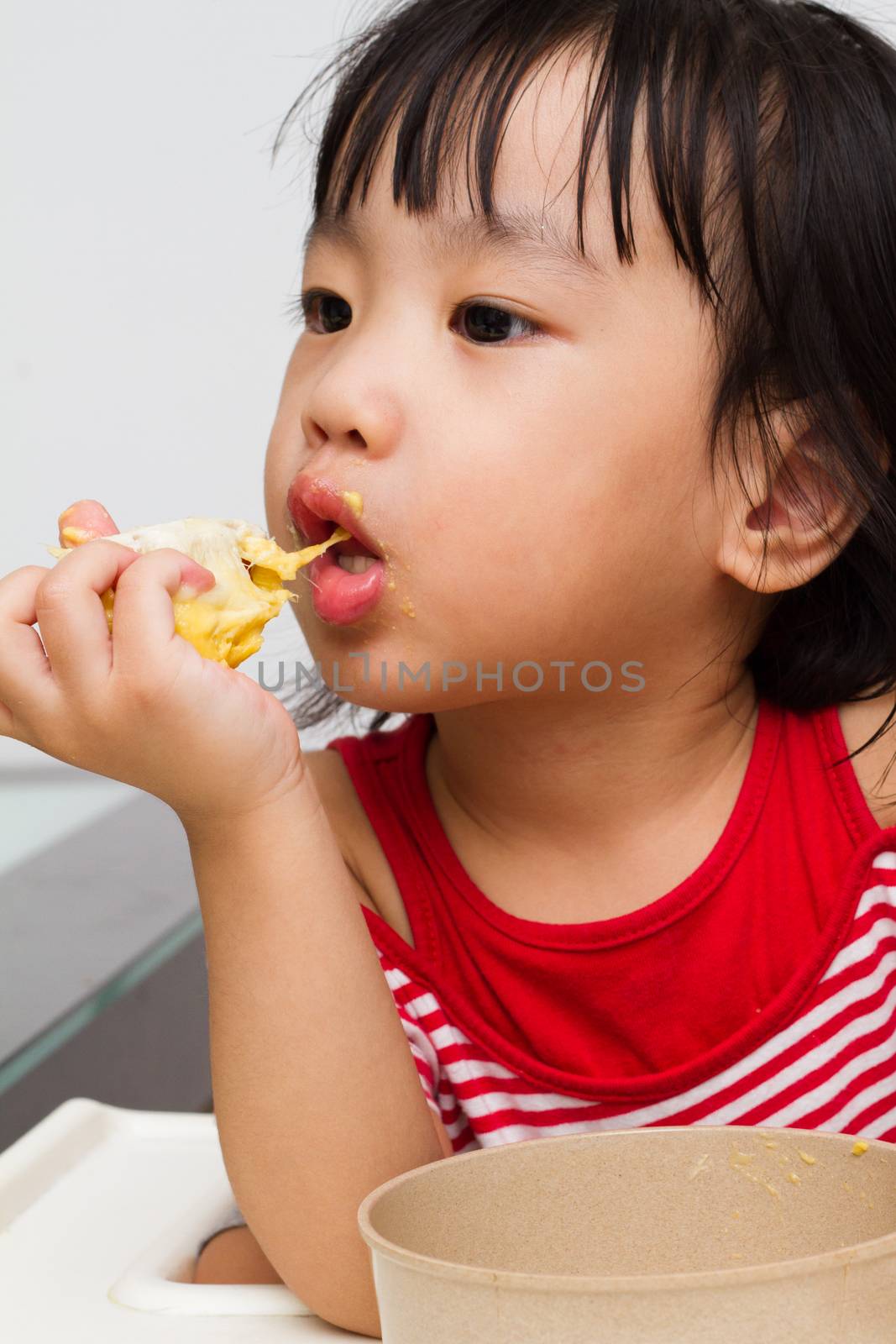 Asian Chinese little girl eating durian fruit