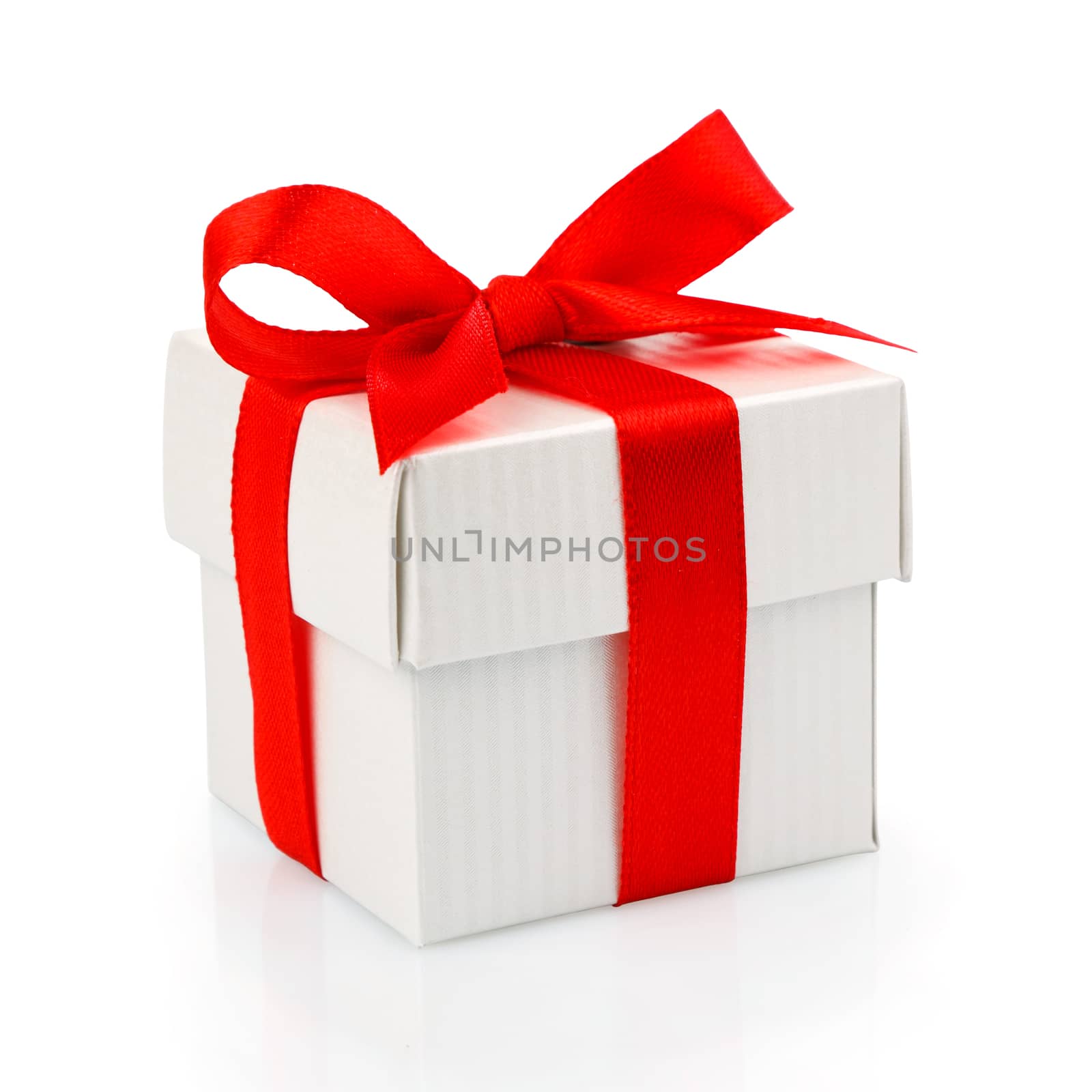white gift box with red ribbon and bow isolated on white with clipping path