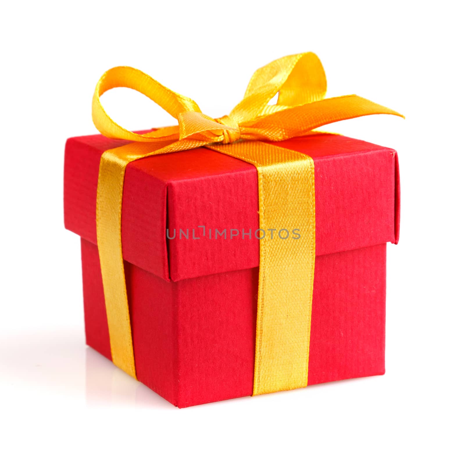 red gift box with golden ribbon and bow isolated on white 