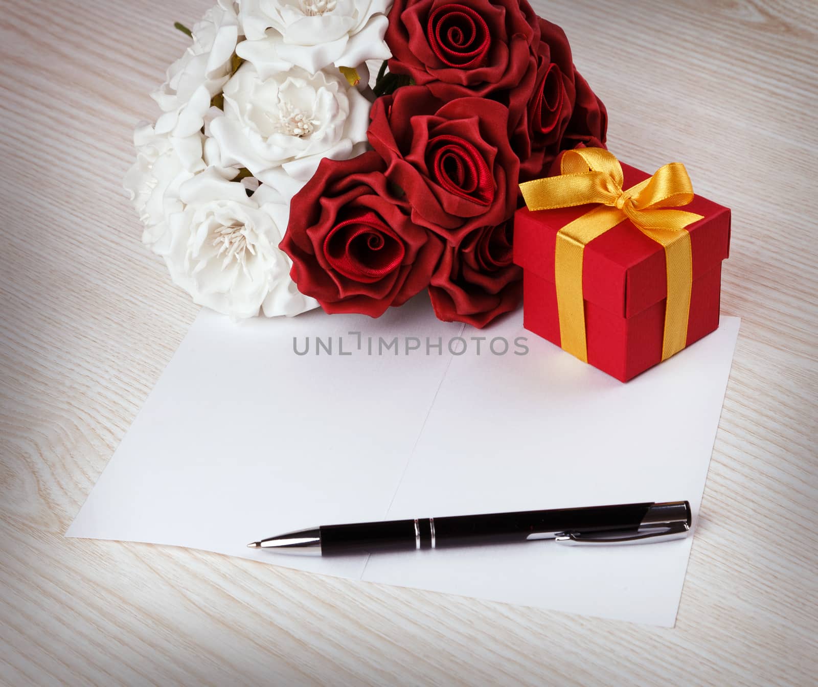 Greeting blank card with pen, rose and red box with yellow ribbon