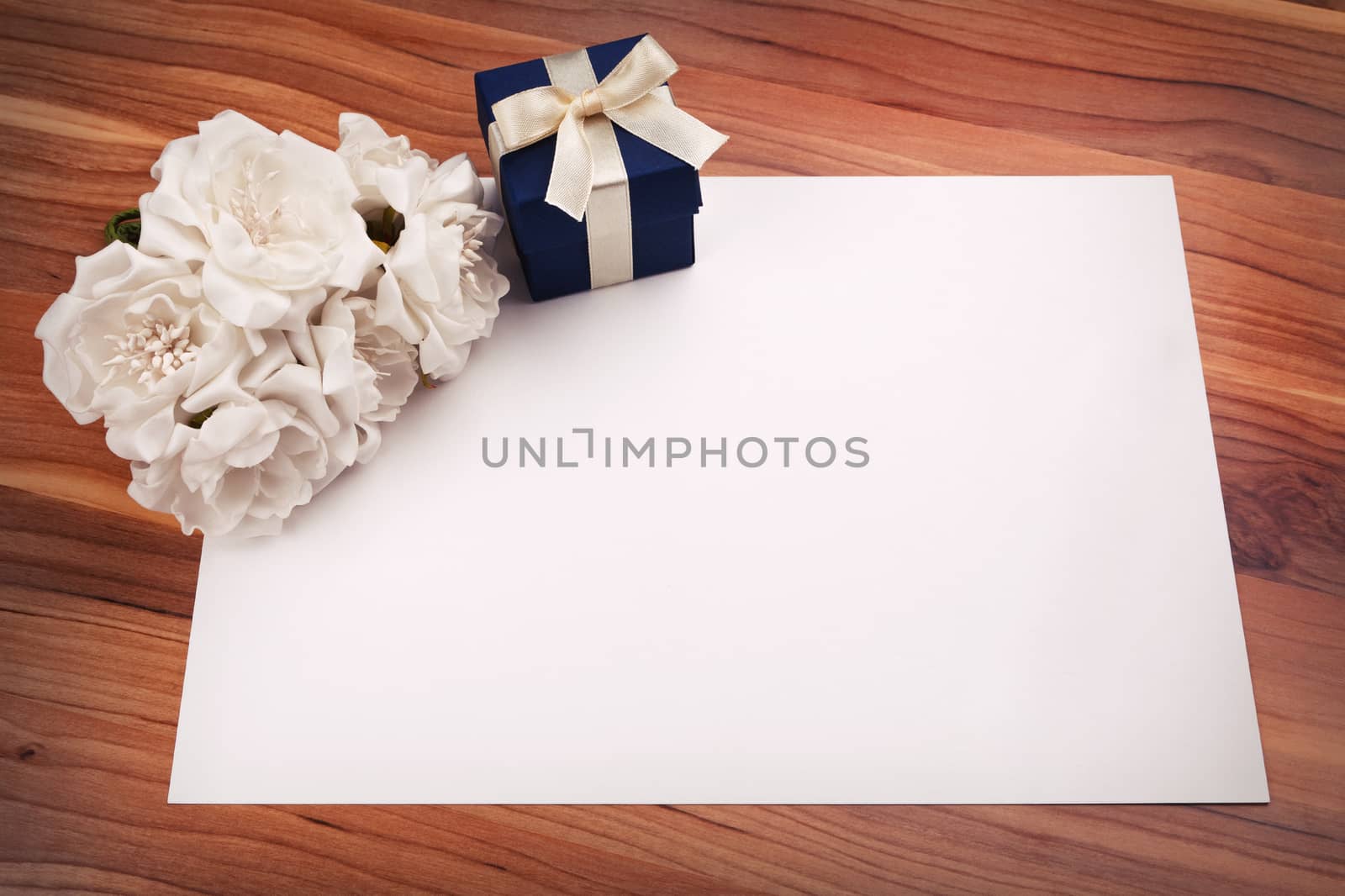 Greeting card with white flowers and a blue gift box