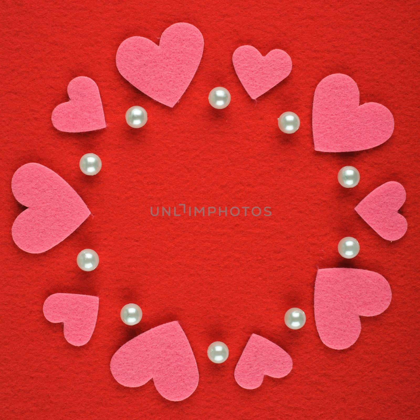 Frame with hearts and pearls on a red background