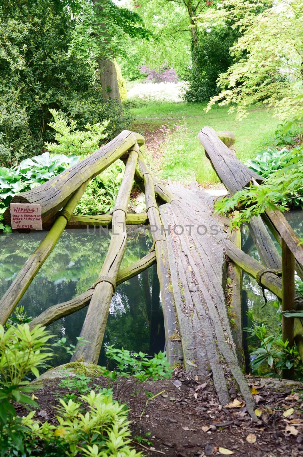 Narrow wooden bridge over stream by pauws99