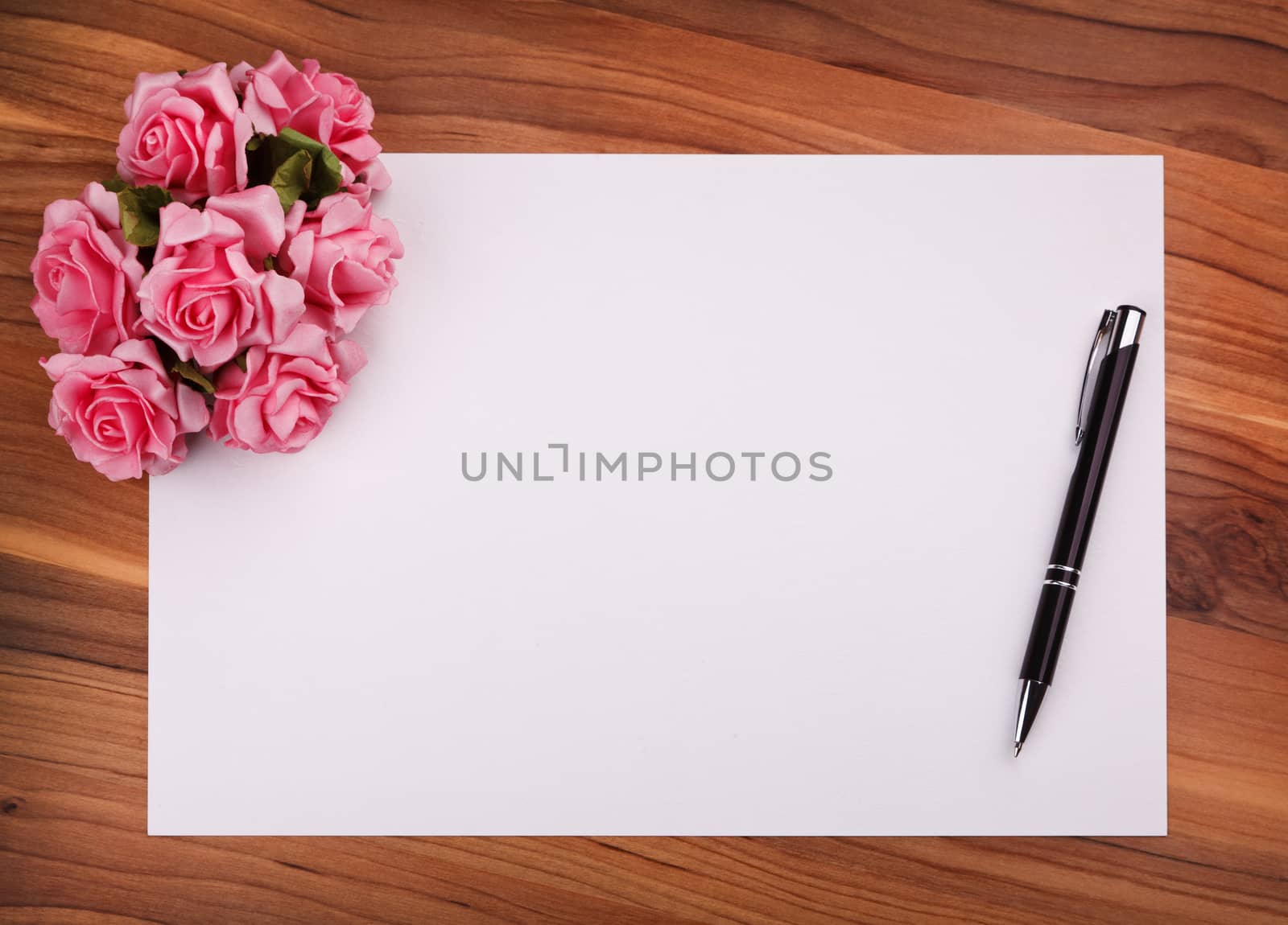 blank card with a pen and pink roses