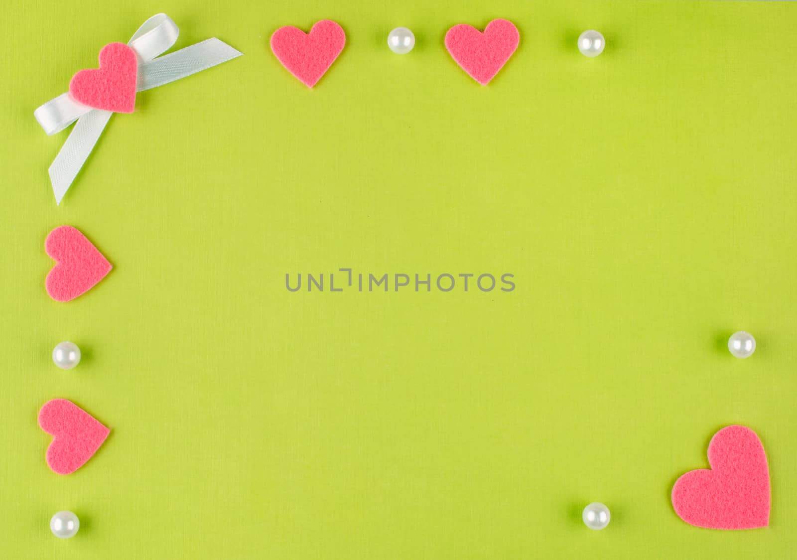 Greeting card with pink hearts on a green background