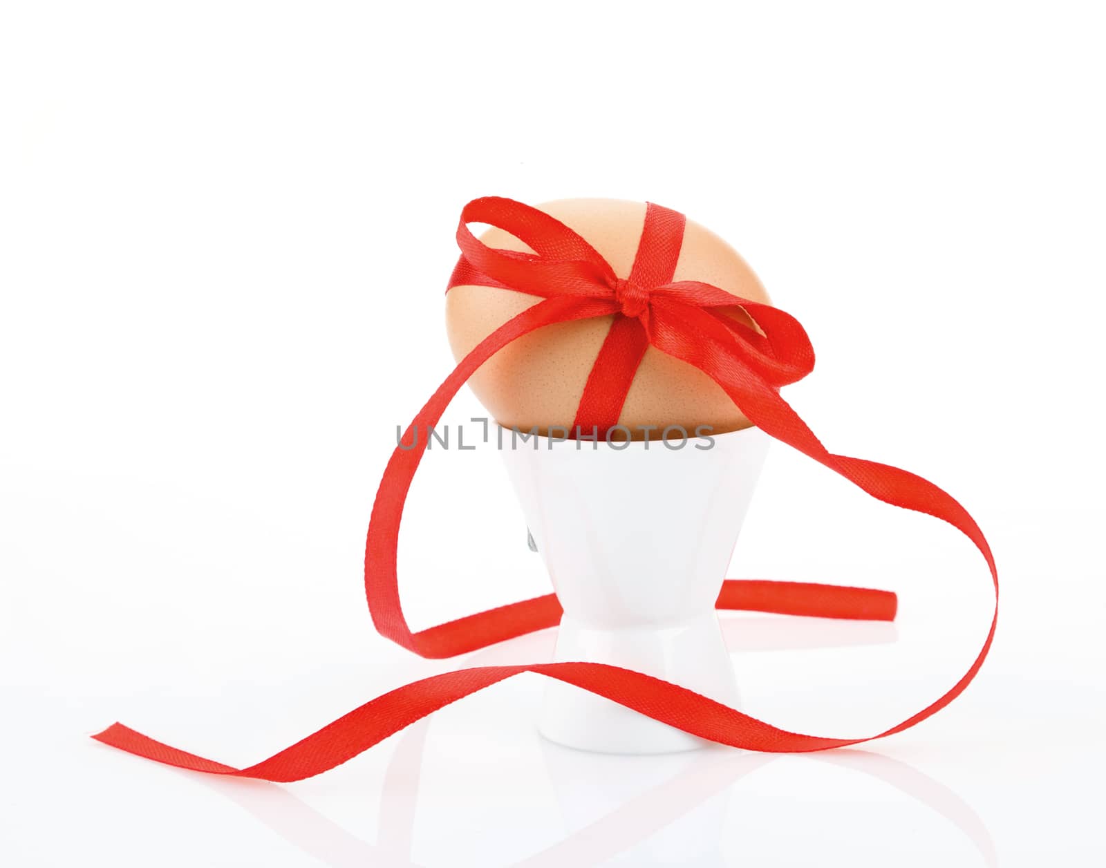  egg with  red festive ribbon isolated on white