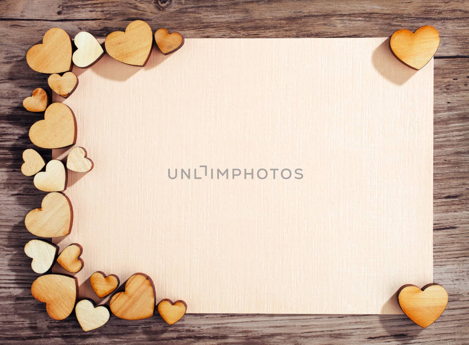 greeting card with a hearts and space for text on a wooden background
