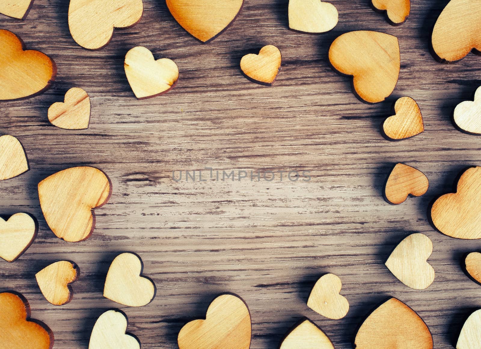 frame with hearts on a wooden background