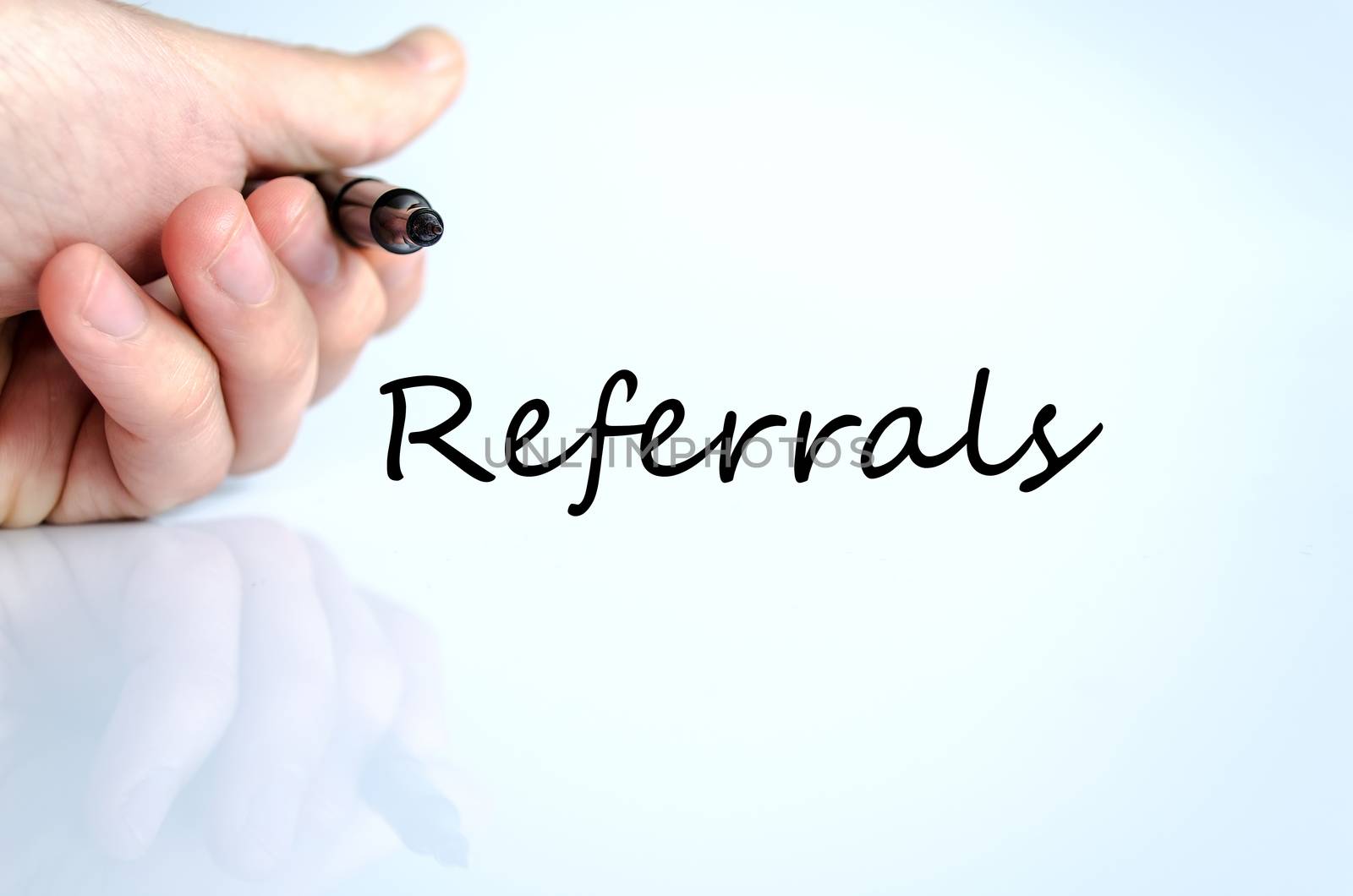 Human hand writing Referrals isolated over white background - business concept