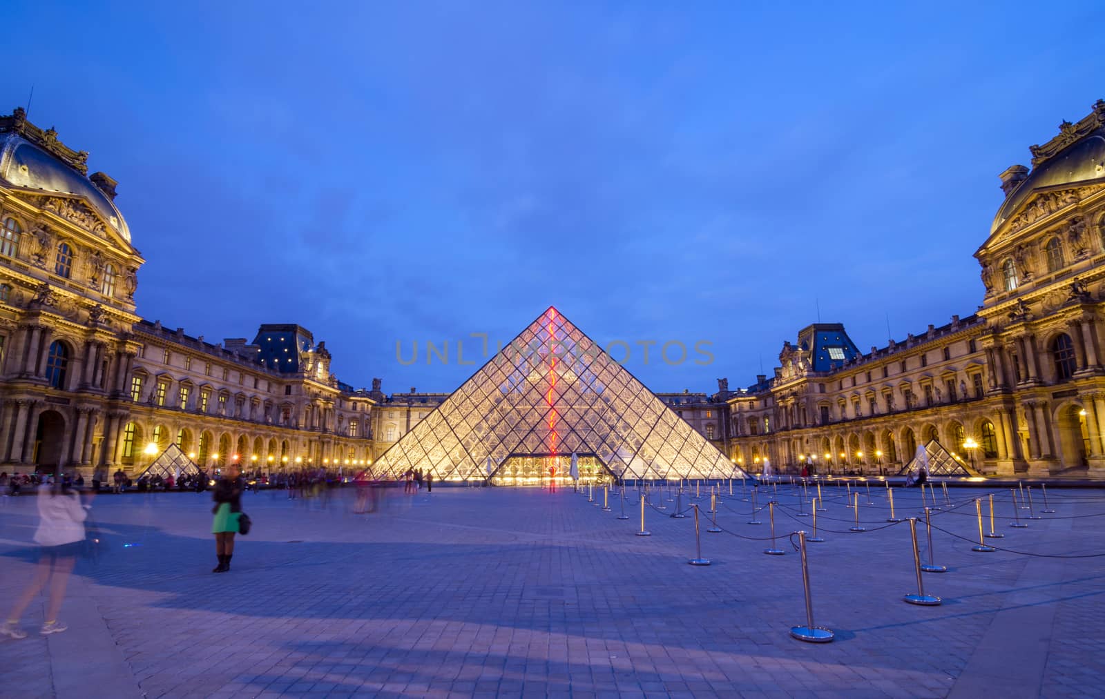 Paris, France - May 14, 2015: Tourist visit Louvre museum at dusk on May 14, 2015 in Paris. Louvre is one of the biggest Museum in the world, receiving more than 8 million visitors each year. 