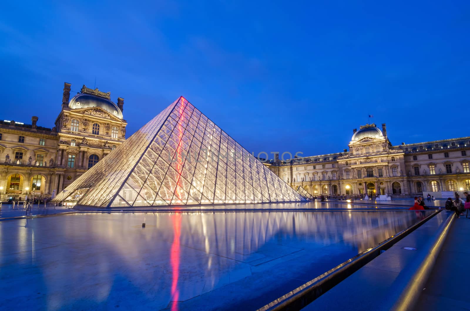 Paris, France - May 14, 2015: Tourist visit Louvre museum at twilight by siraanamwong