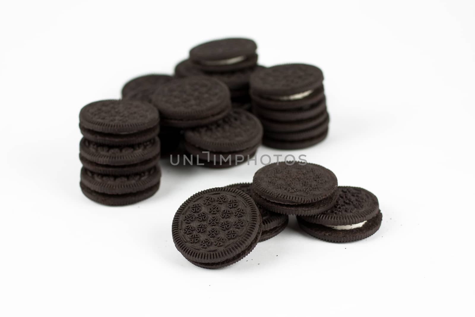 Chocolate sandwich cookies with vanilla creme filling isolated on white.