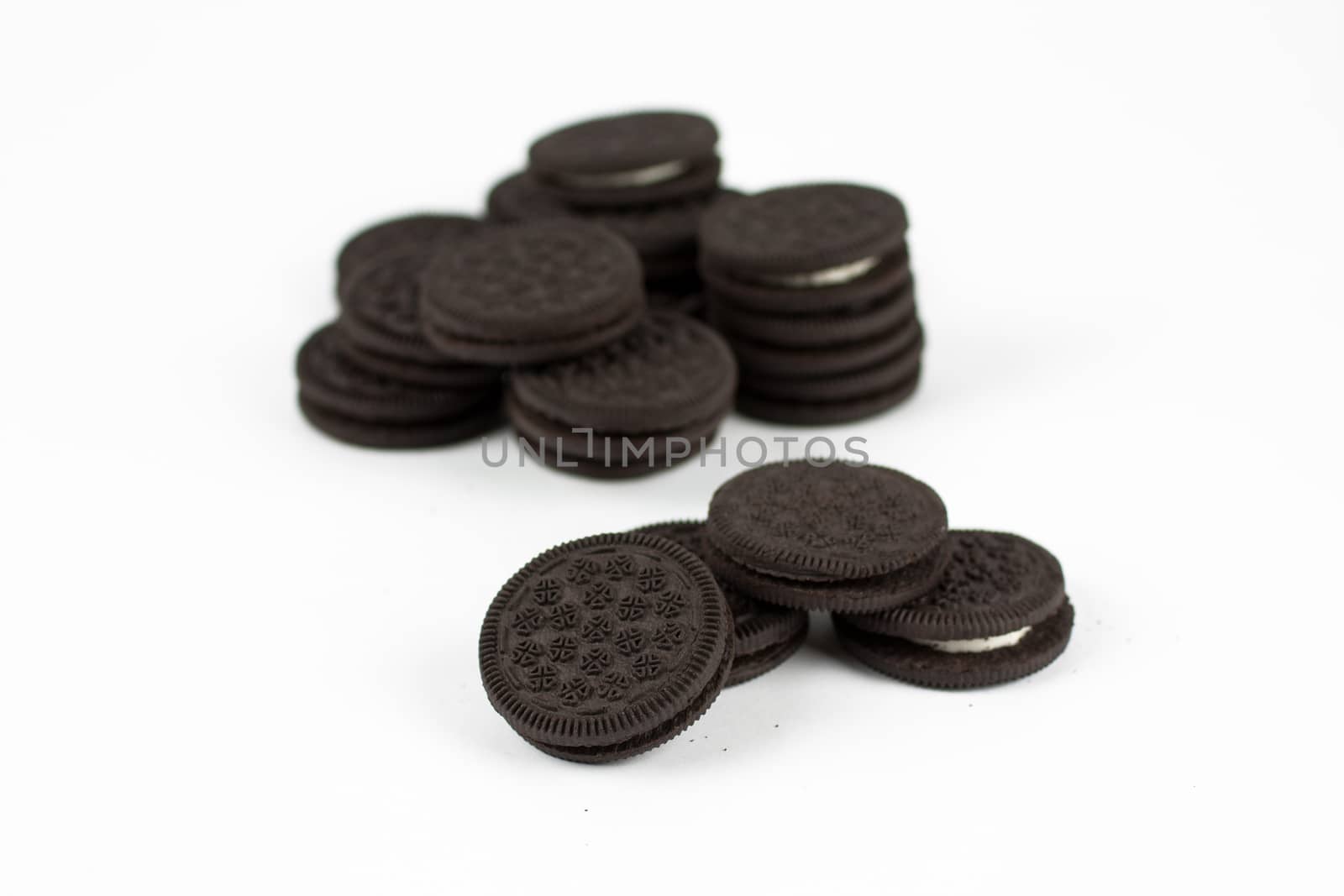 Chocolate sandwich cookies with vanilla creme filling isolated on white.